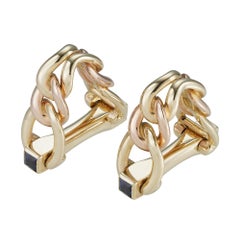 A pair of Cartier gold and sapphire stirrup cufflinks