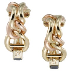 A pair of Cartier gold and sapphire stirrup cufflinks