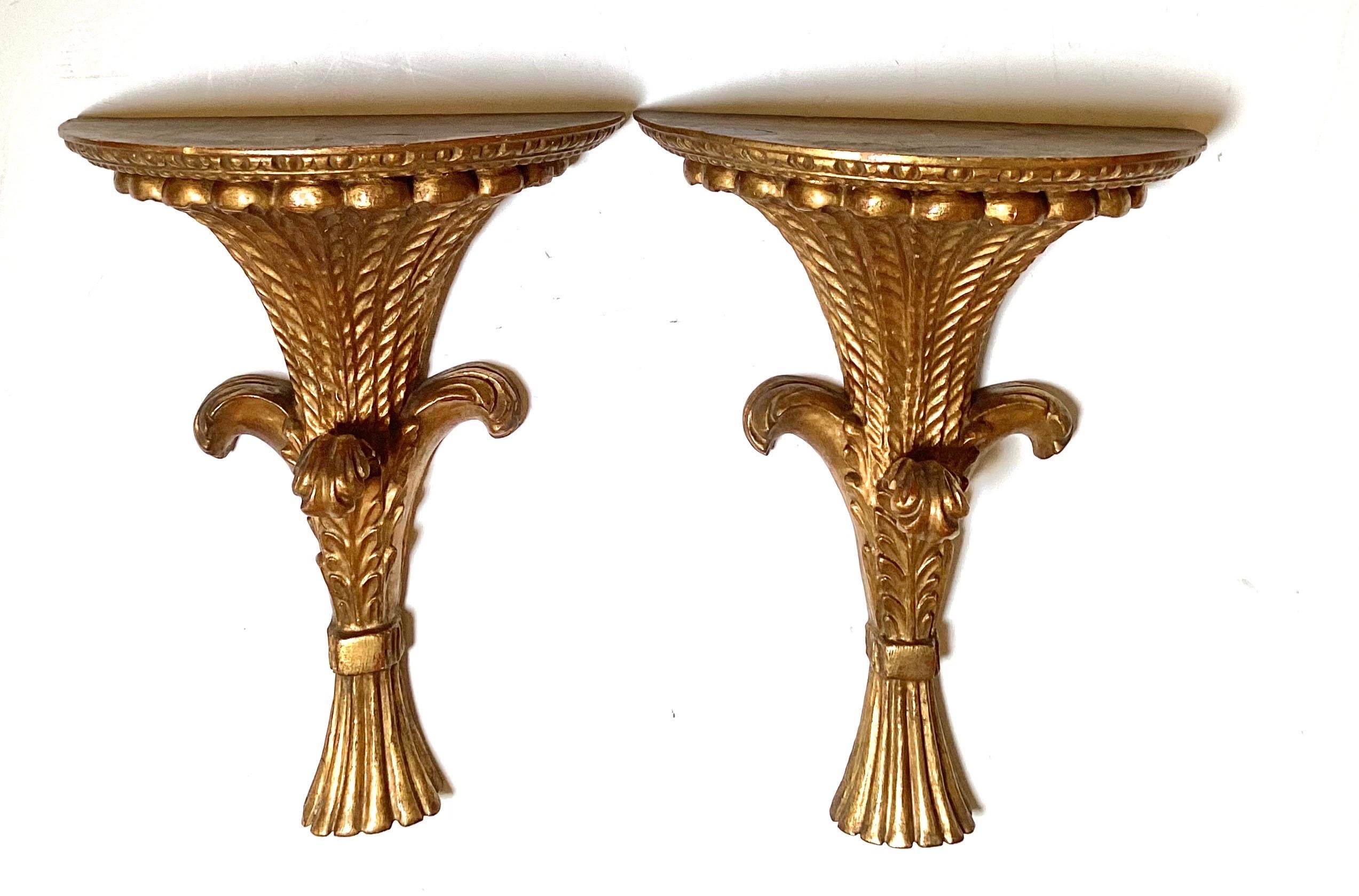A pair of giltwood wheat motif wall shelves, Italy, mid 20th Century, the good size measuring 15 inches high, 12.5 inches wide, and 6 iches deep. 
