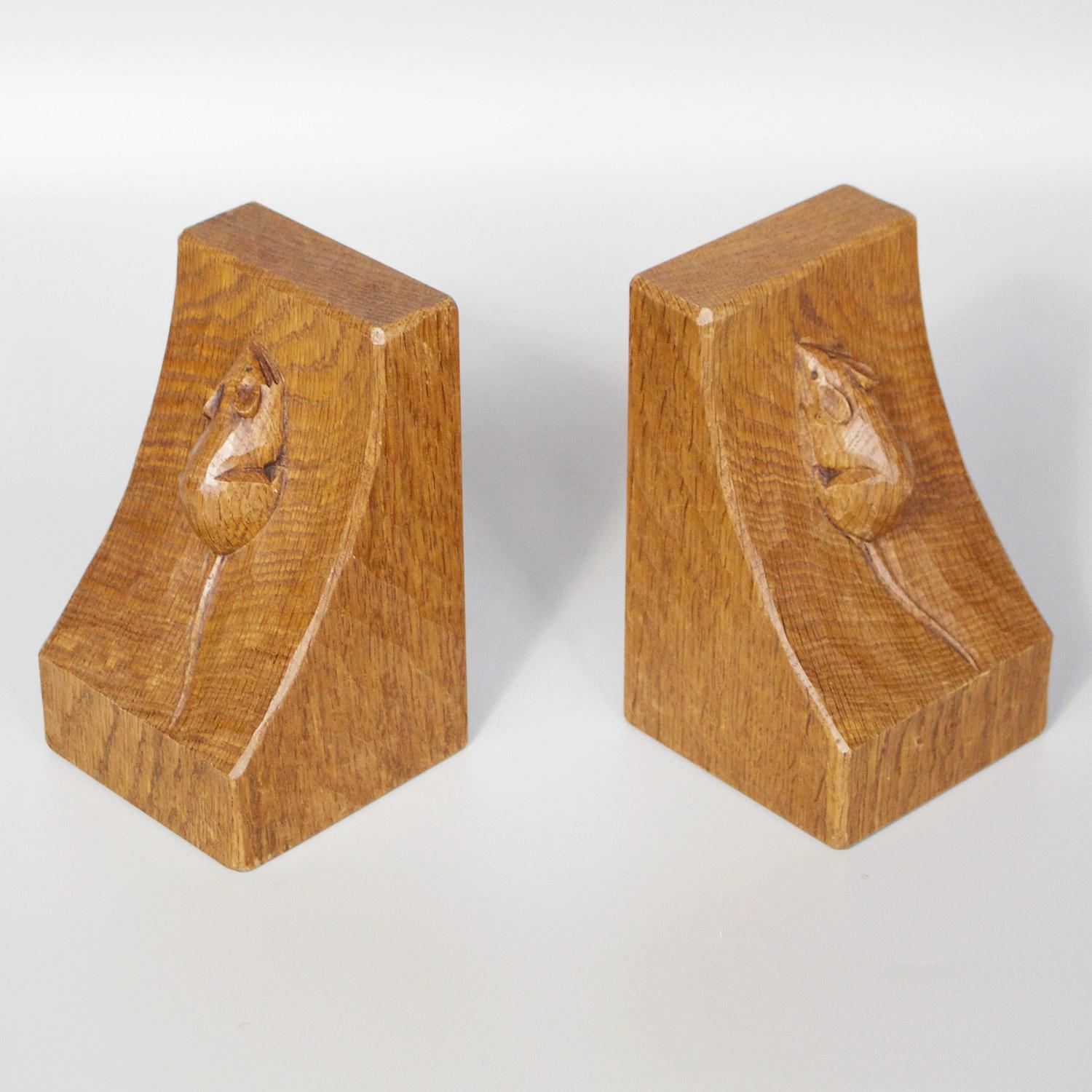 Pair of bookends by Robert 'Mouseman' Thompson. Carved and adzed oak with a climbing mouse on each bookend. 

Dimensions: H 9cm W 15cm D 9cm

Origin: English

Date: Circa 1950

Item Number: 2101212