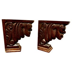 A Pair of Carved Oak Wall Brackets Caryatid Guardians