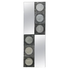 A pair of cast aluminium mirror by Garinei Bia