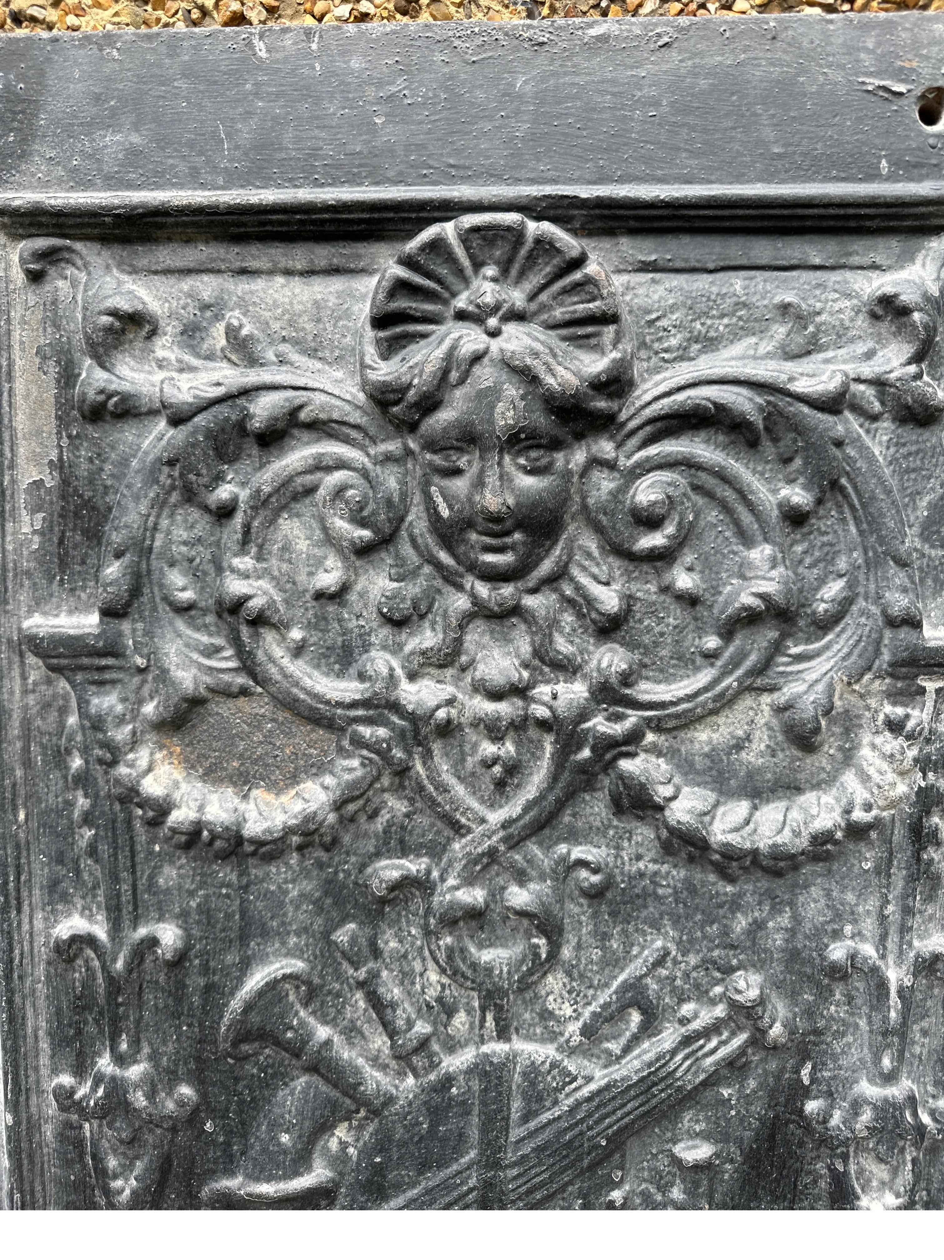 A lovely pair of English cast iron panels. Decorated with  beautiful ladies heads , with musical instruments and Griffins and foliage . 