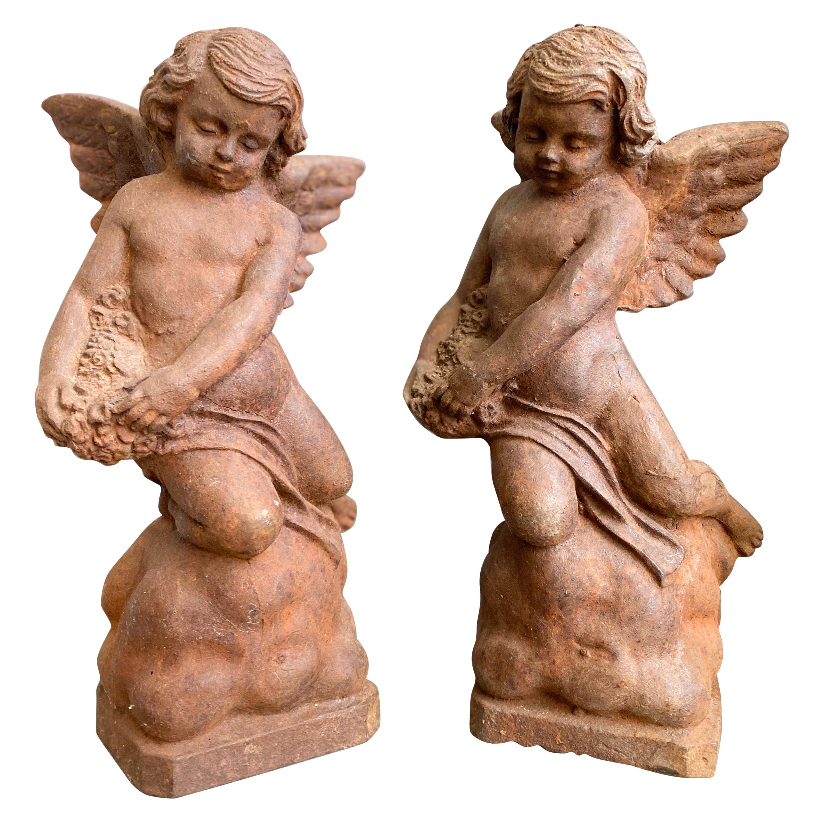 Pair of Cast Iron Putti Figures For Sale