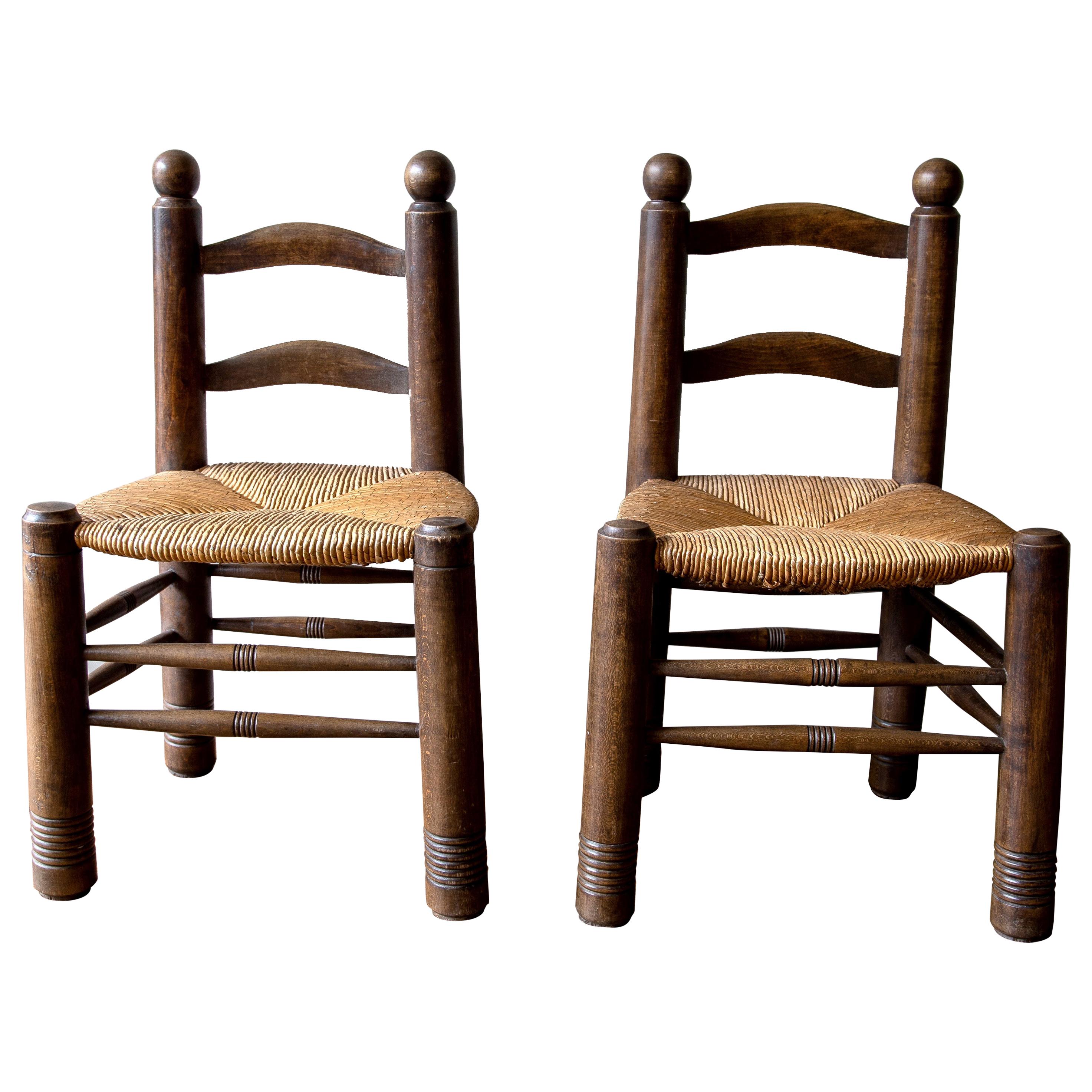 A pair of Catalan Racionalist Walnut and Rush Seated Finca Chairs, circa 1950