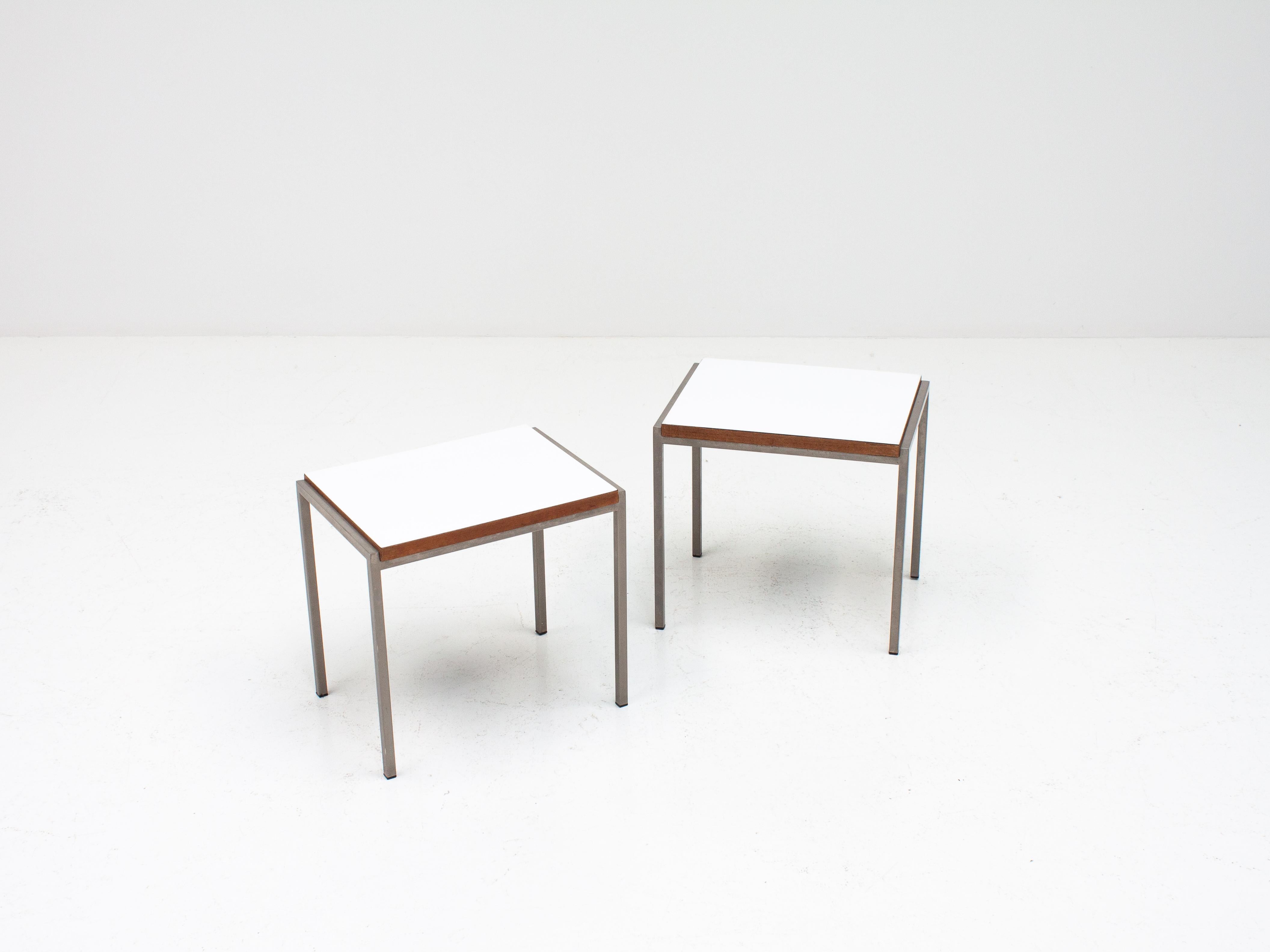 A fine pair of white laminate and teak veneered side tables with metal frames designed by Cees Braakman for UMS Pastoe in the 1960s, Netherlands

In good condition for age, you should expect light scratches to the laminate tabletops. There are