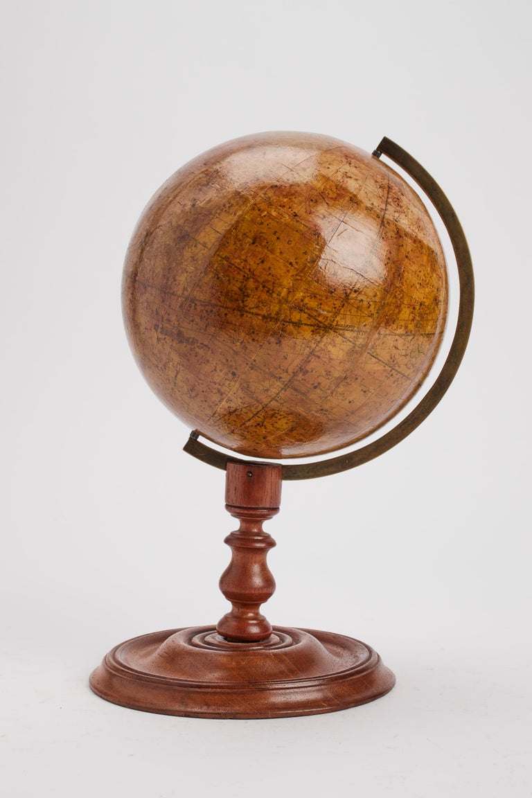 Pair of English globes. Over a wheel turned oak wooden base, with the round foot, with a perfect patina, is placed a Celestial globe, edited by Malbey, London. The globe is made out of papier-mache, finished with pastiglia refined chalk, and