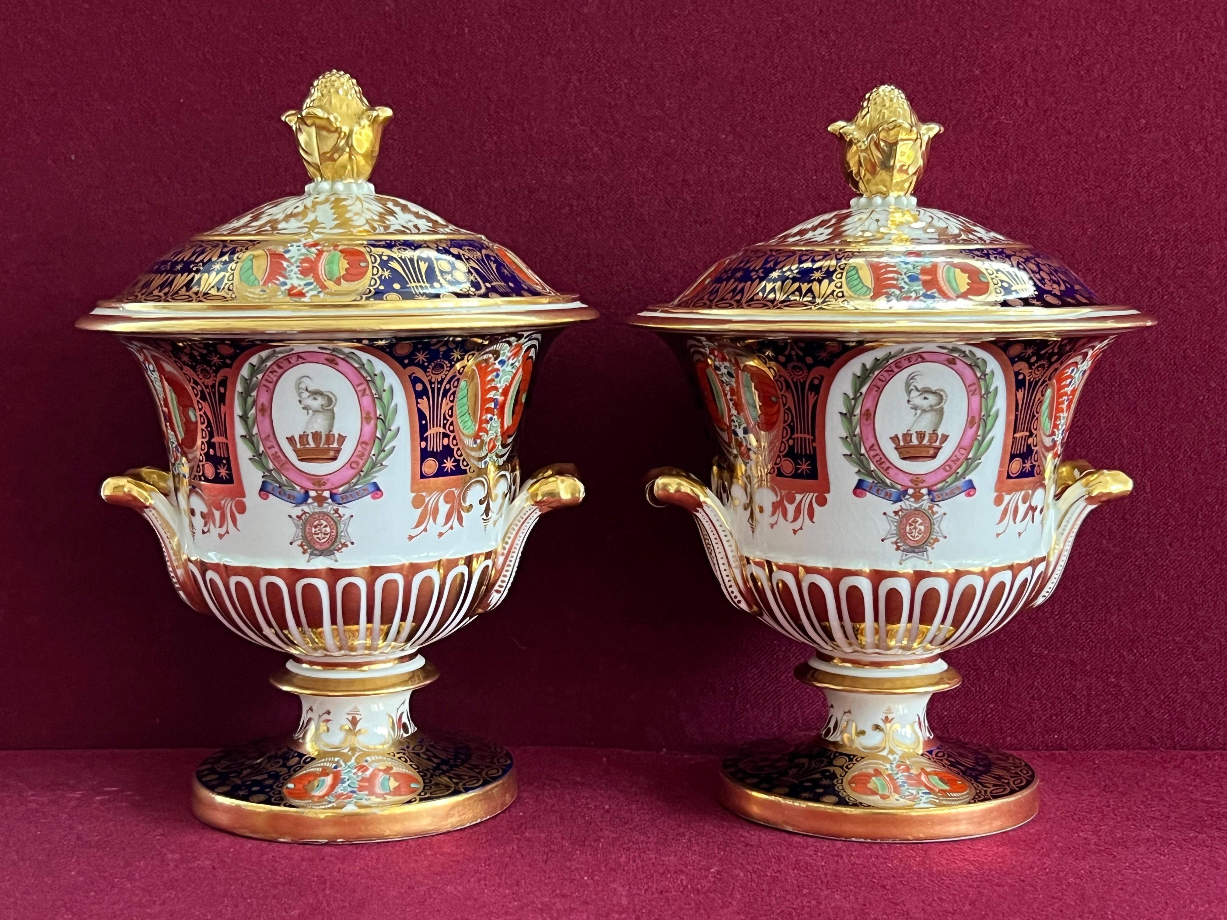 A pair of Chamberlain Worcester armorial dessert tureens and covers from the Admiral Yeo service c.1815-1820, each of twin-handled semi-reeded campana form on spreading foot, painted and enriched in gilding with the crest, motto and Badge of the