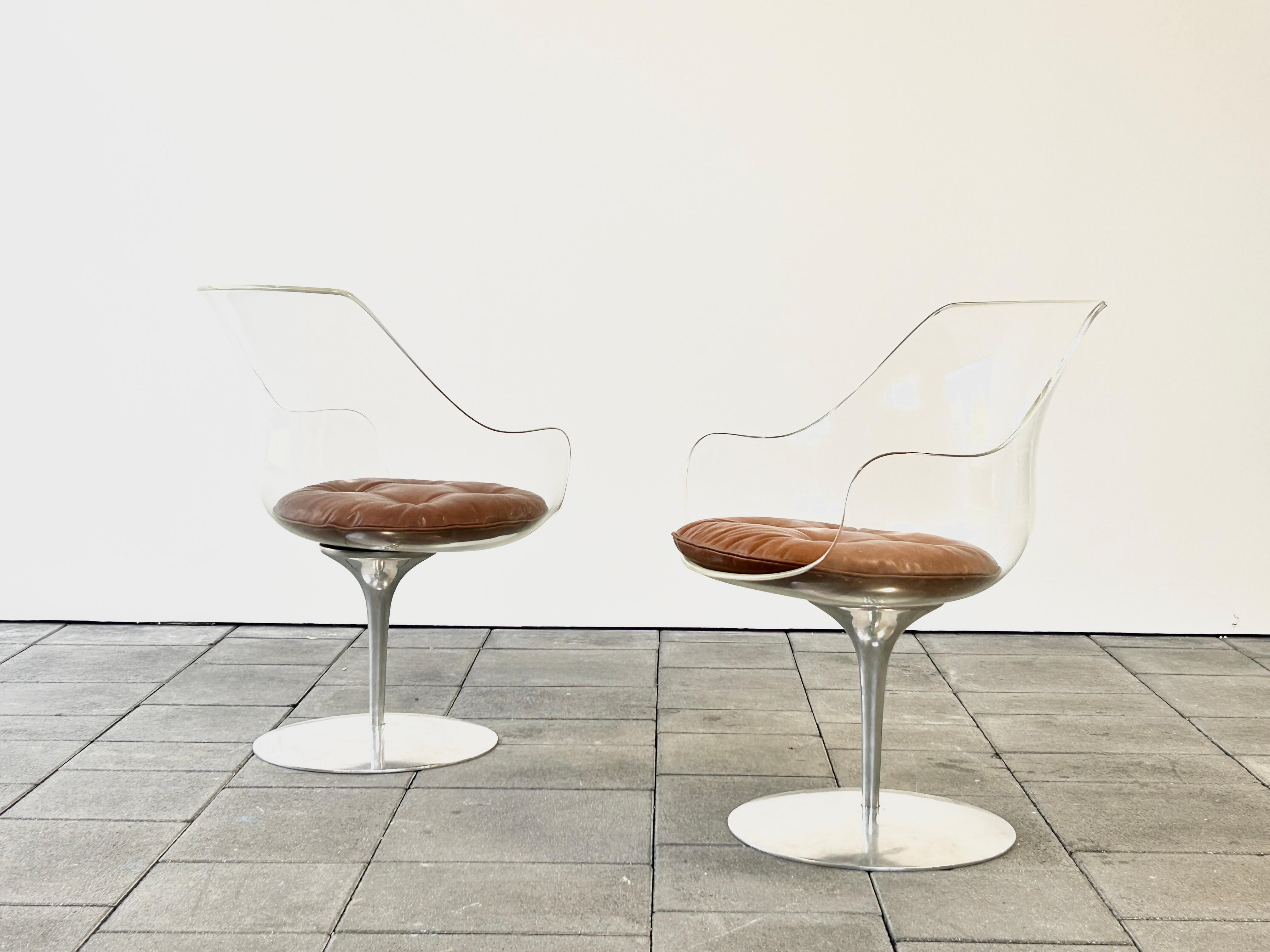 Set of two lucite Champagner chairs designed by Erwine & Estelle Laverne, ca. 1960

With it’s transparent lucite seat shell and Aluminium base the Champagner chair offers a highly esthetic elegance and comfort. The revolving shivel base