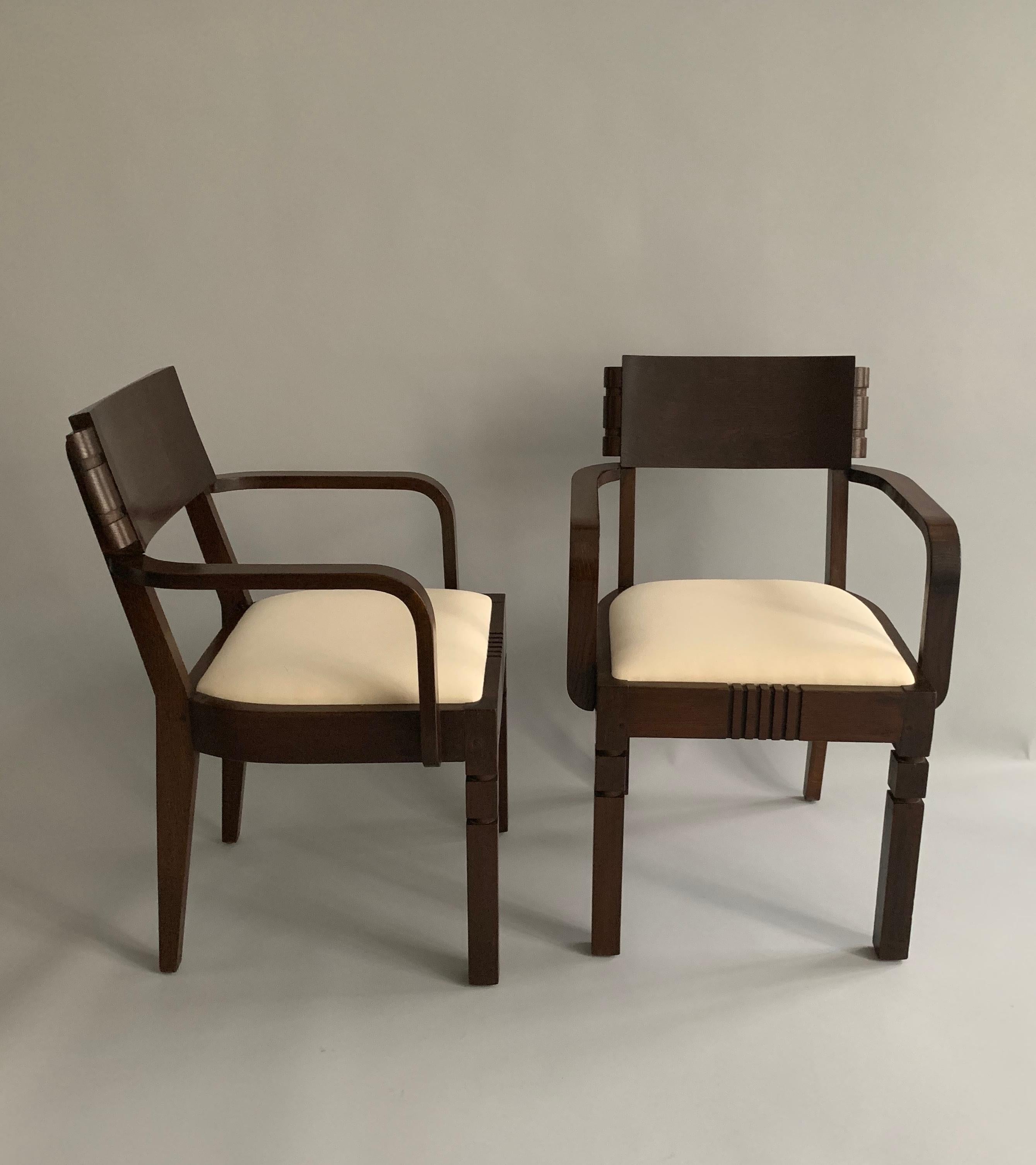 A pair of oak armchairs (signed below) by Charles Dudouyt.