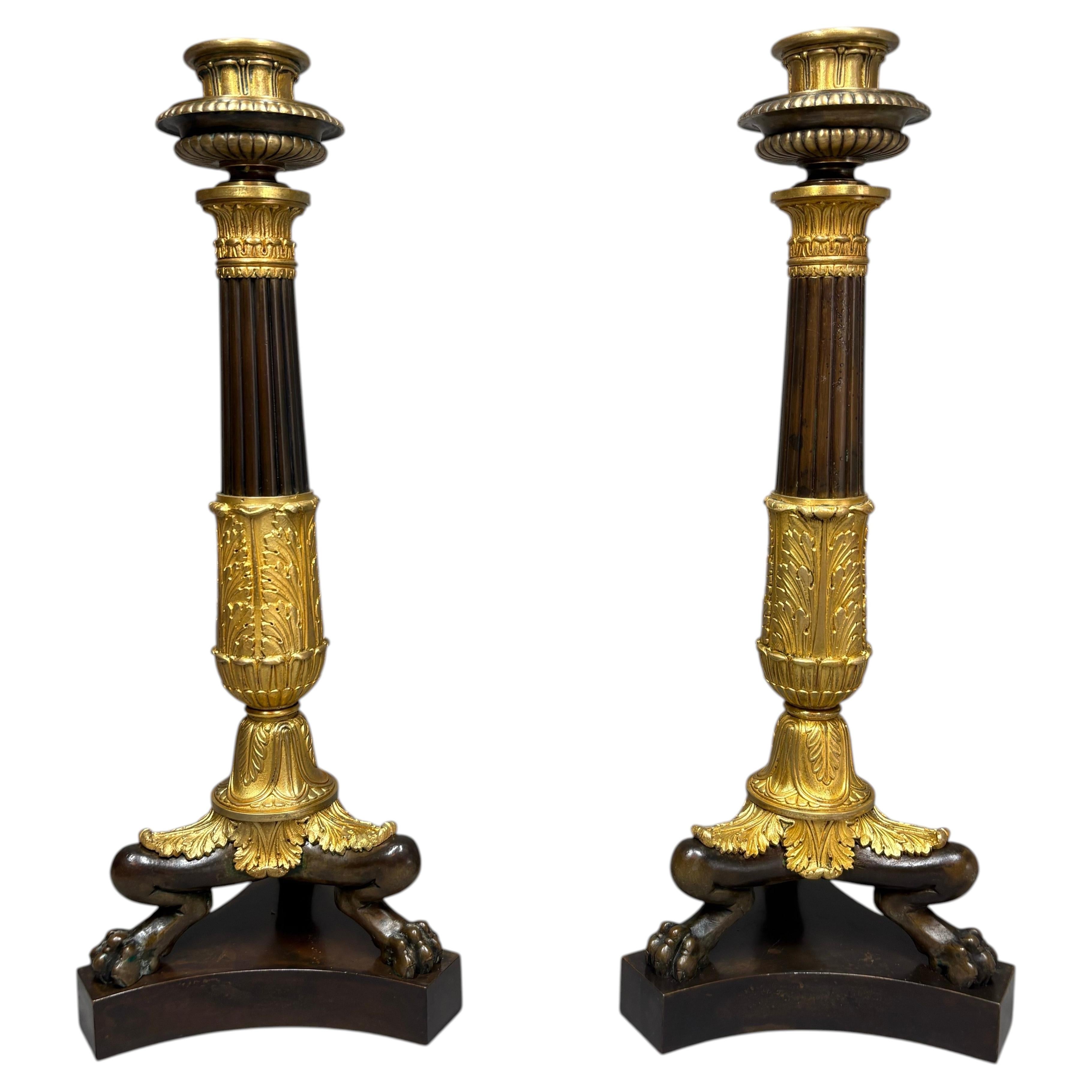 A pair of Charles X or Louis-Philippe neoclassical bronze candlesticks