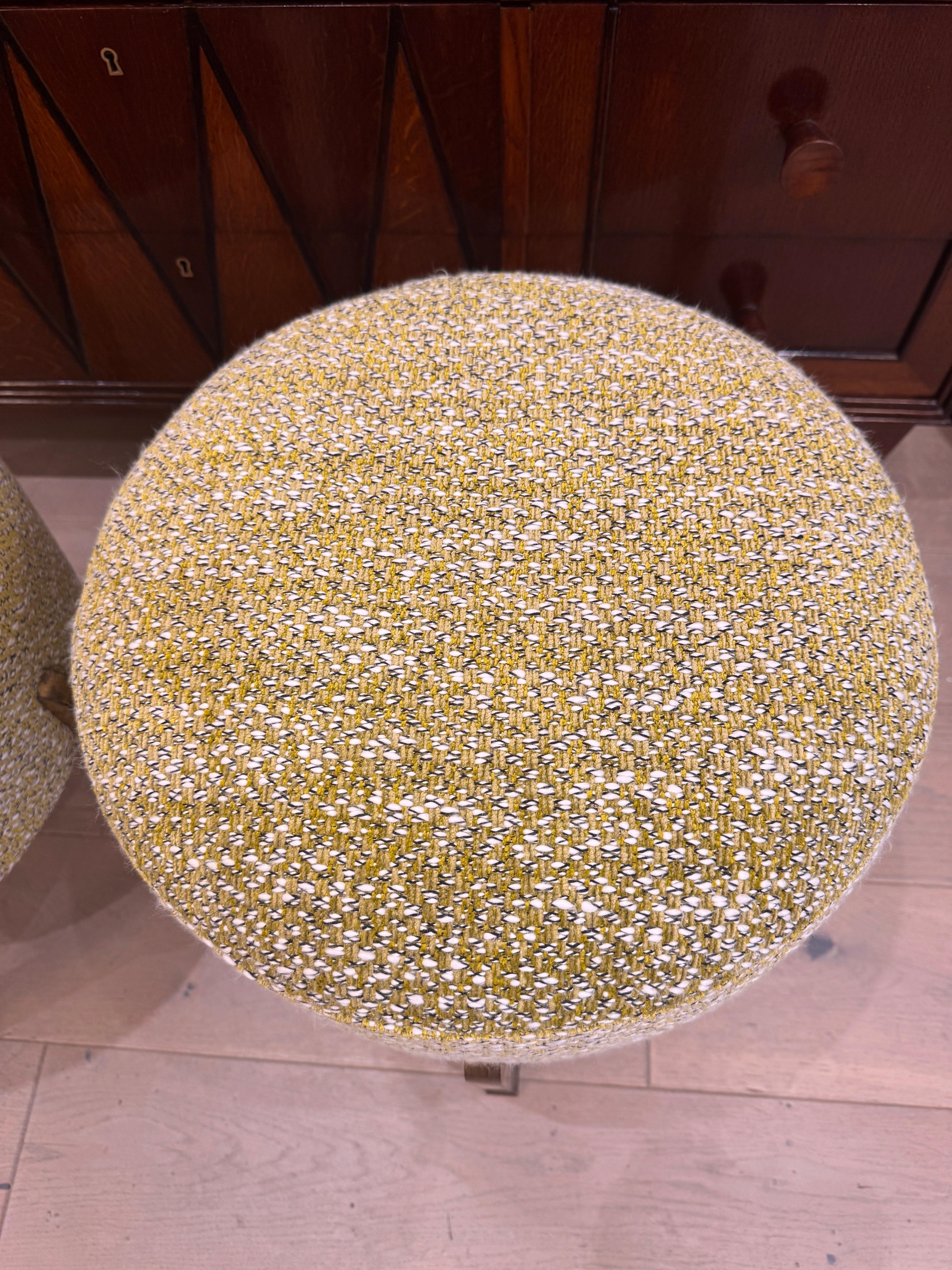 A charming pair of Italian 1960s ottomans/poufs standing on 4 gilded bronze with patina legs newly upholstered in Chartreuse boucle . 
