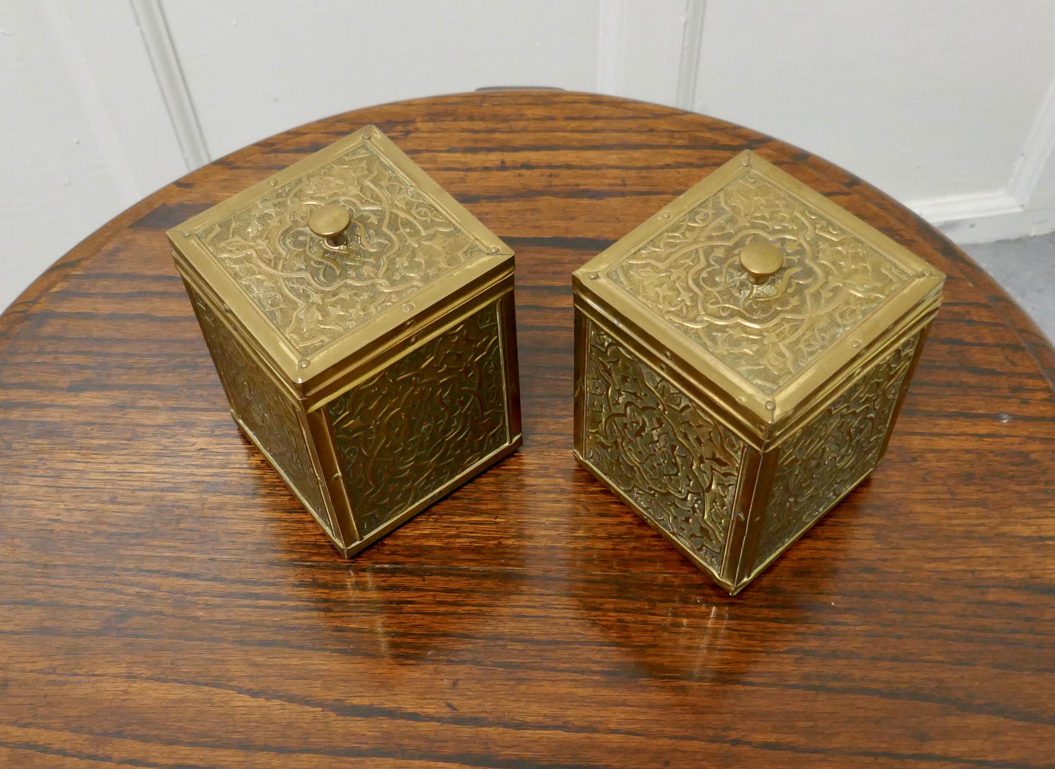 A pair of chased brass tea caddies 

A very attractive pair of caddies, they are square and have an eastern look to the decoration
The are 4” square and 6” high
TGB400.
  