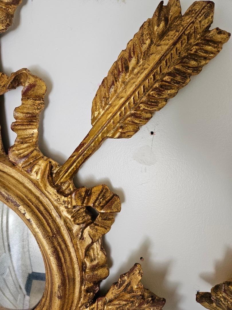 A fabulous pair of Louis XV Style gilt wood wall trophies with bulls eye mirrors. The gilt wood with arrows and quivers made by Chelsea House, know for high quality decorator items, marked on back. 