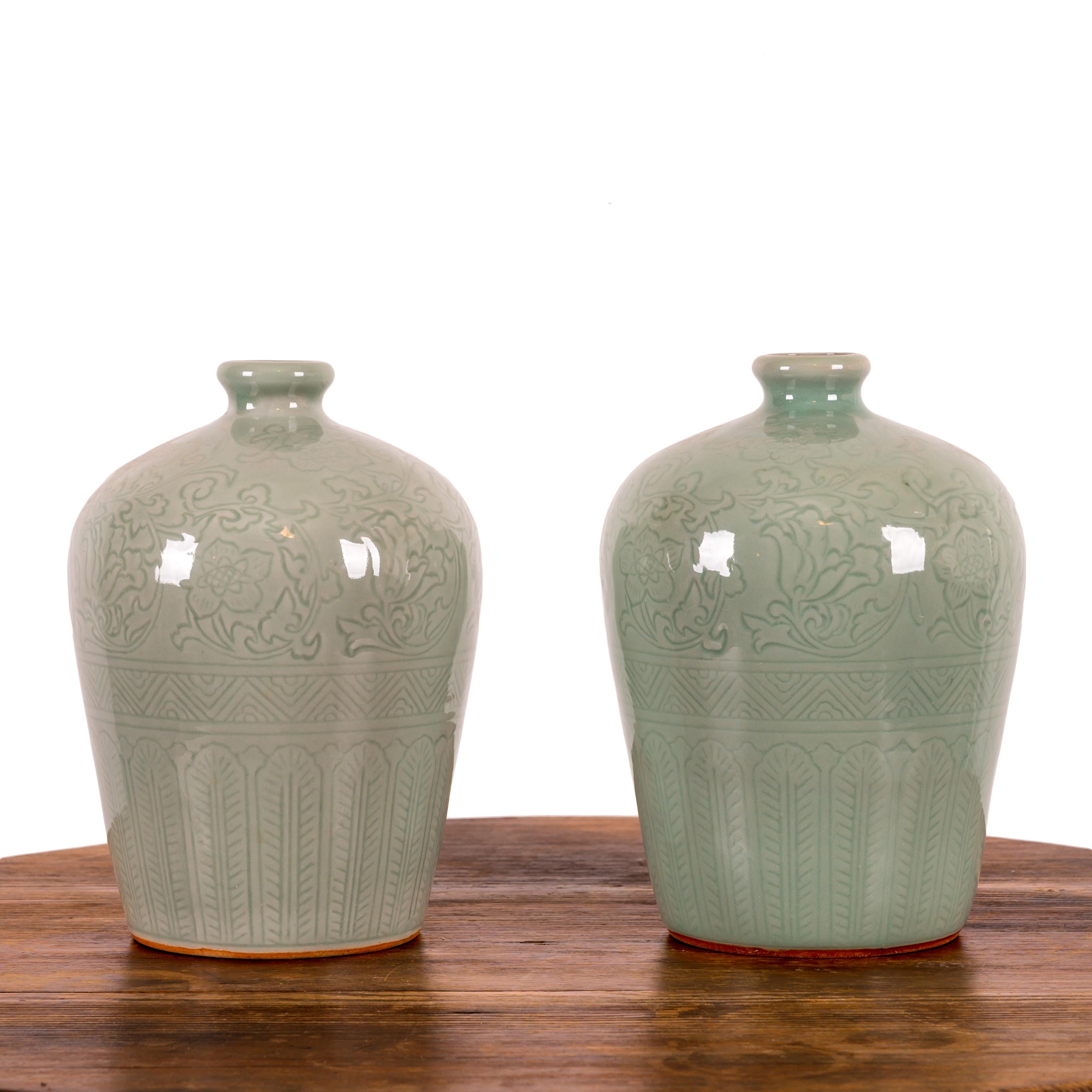A pair of Chinese celadon vases, 20th century.

6 ½ inches wide by 8 ¾ inches tall



