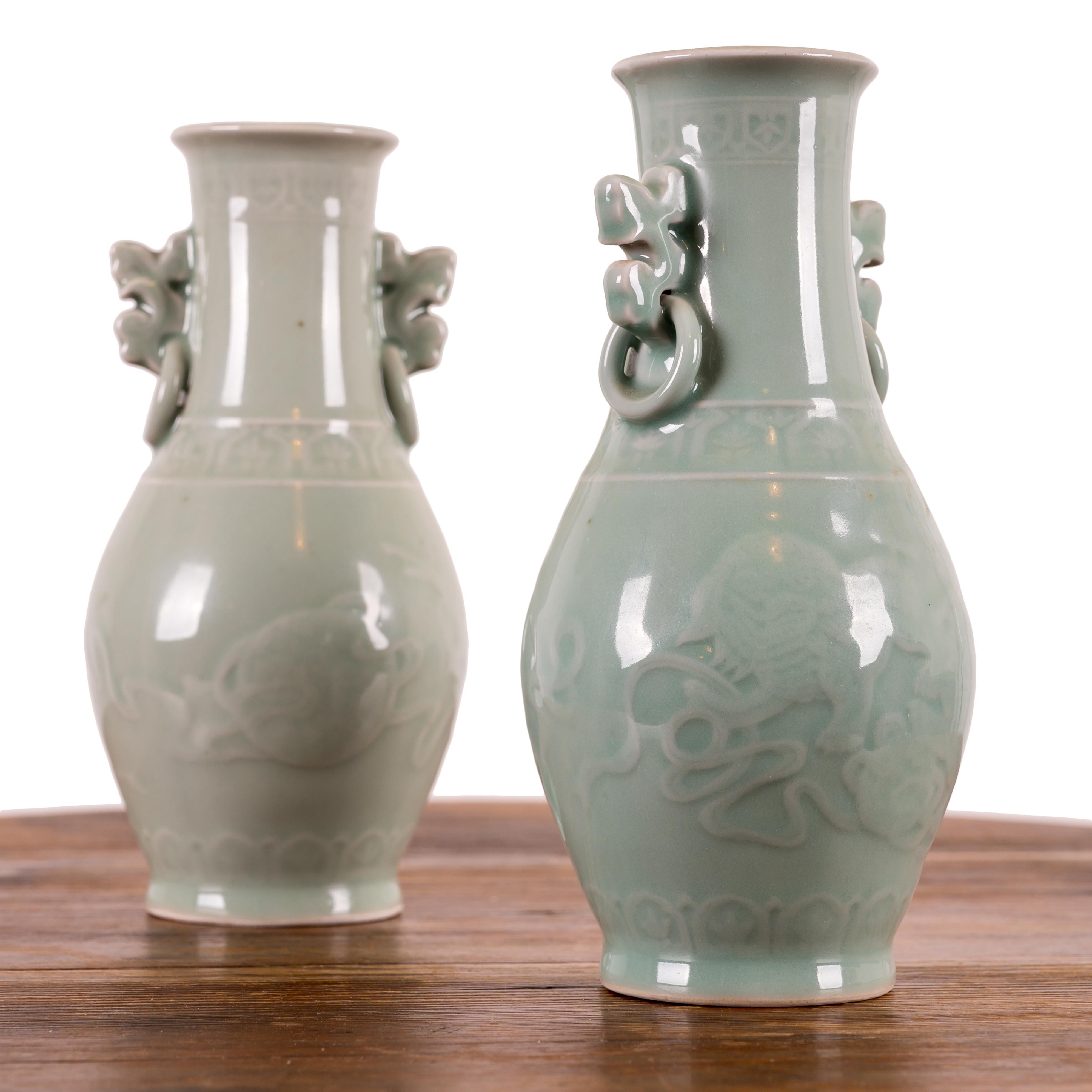 A pair of Chinese celadon vases, 20th century.

4 inches wide by 8 inches tall



