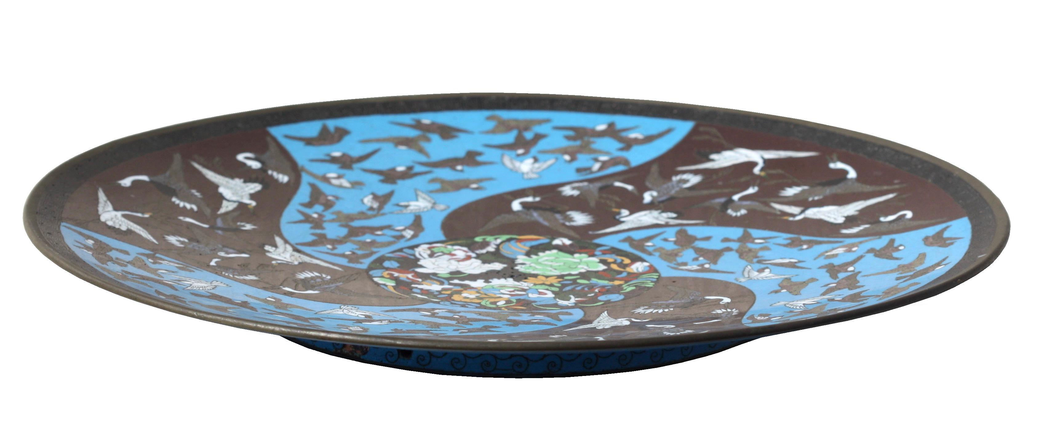 A pair of Chinese cloisonné enamel plates
decorated with birds on a light blue ground
Measure: Diameter 11 3/4 inches.