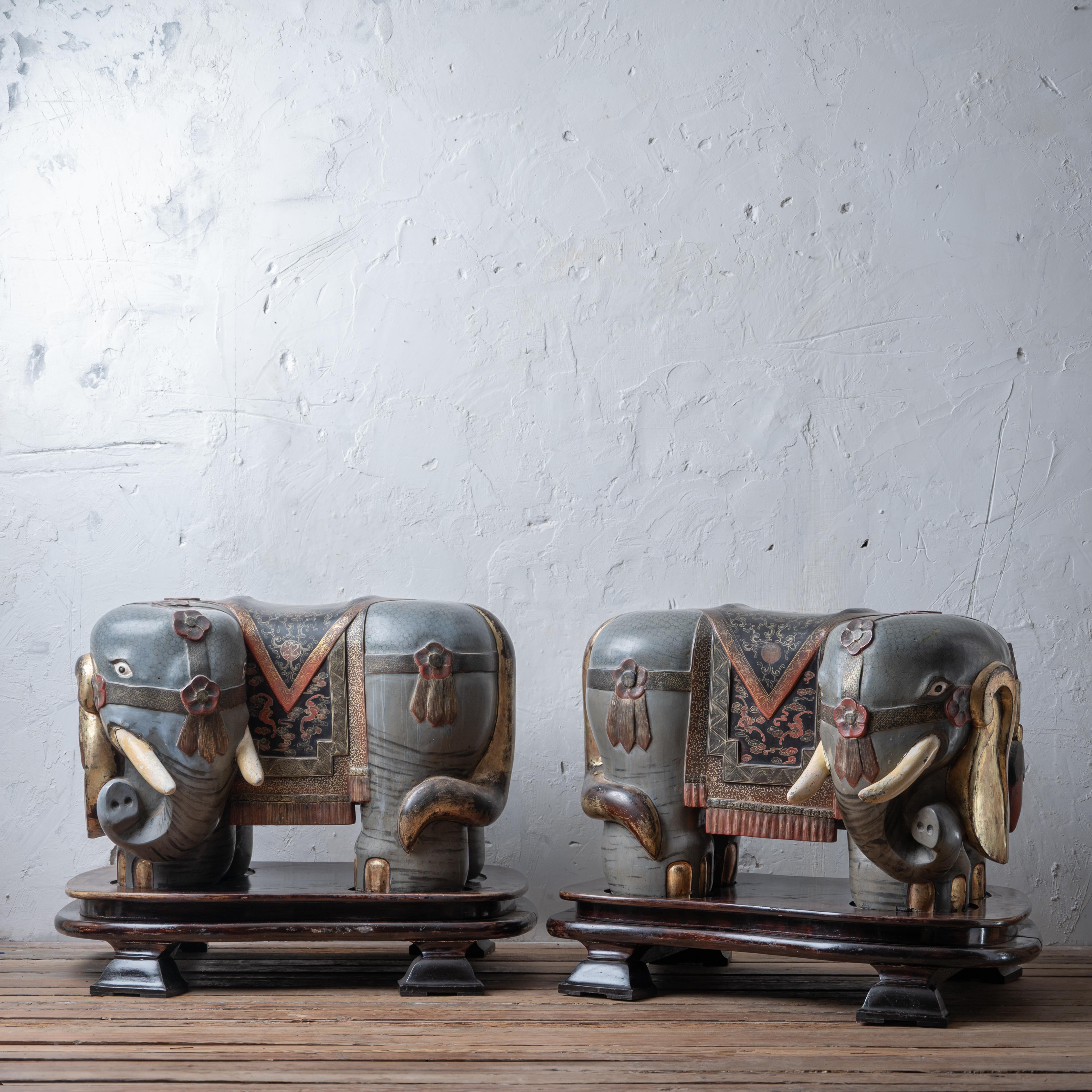 A pair of Chinese export elephant form garden stools, early 20th century.

Carved wood with gilding and painting.  On custom built plinths.  Weighing over 100 pounds each. 

overall: 38 inches wide by 29 inches deep by 29 inches tall

without bases: