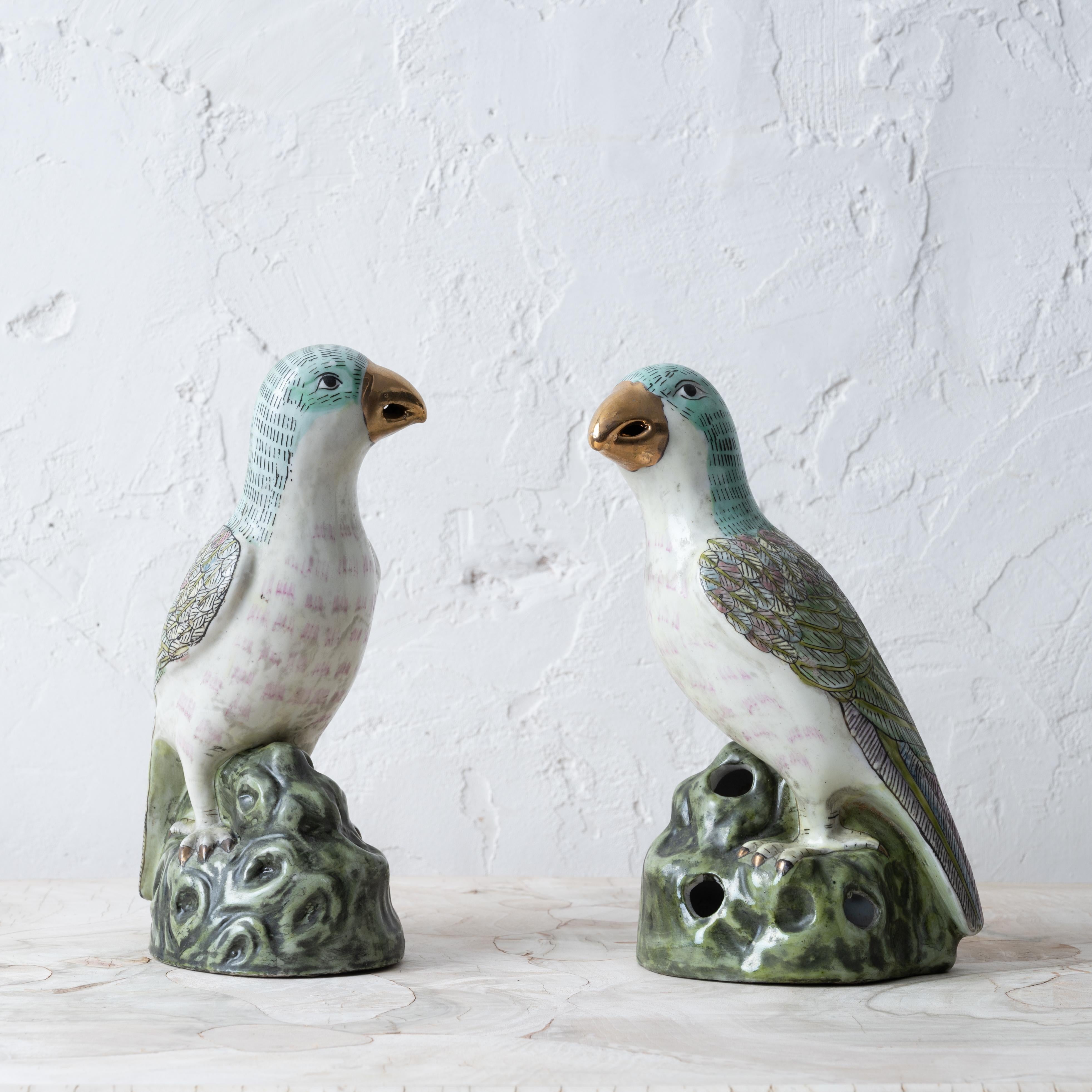 A pair of Chinese export famille verte porcelain parrots with gilt beaks, 20th century.

4 inches wide by 5 ½ inches deep by 9 ¾ inches tall

