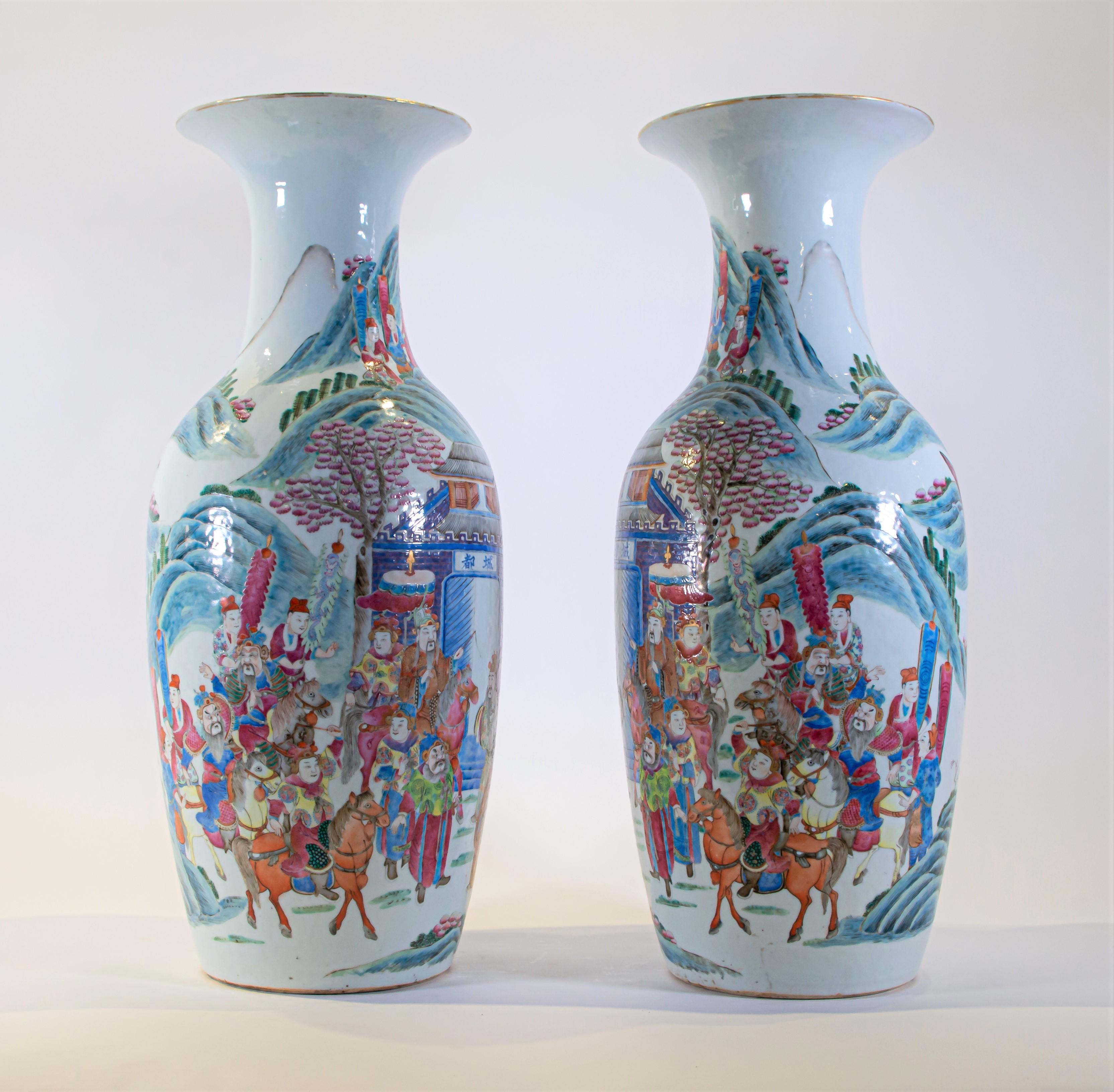 An exceptional and large pair of hand painted antique Chinese Famille rose Emperor scene vases. Of baluster form these vases are both large and beautifully decorated in multicolored hues that include red, green, purple, brown, orange, yellow, blue,