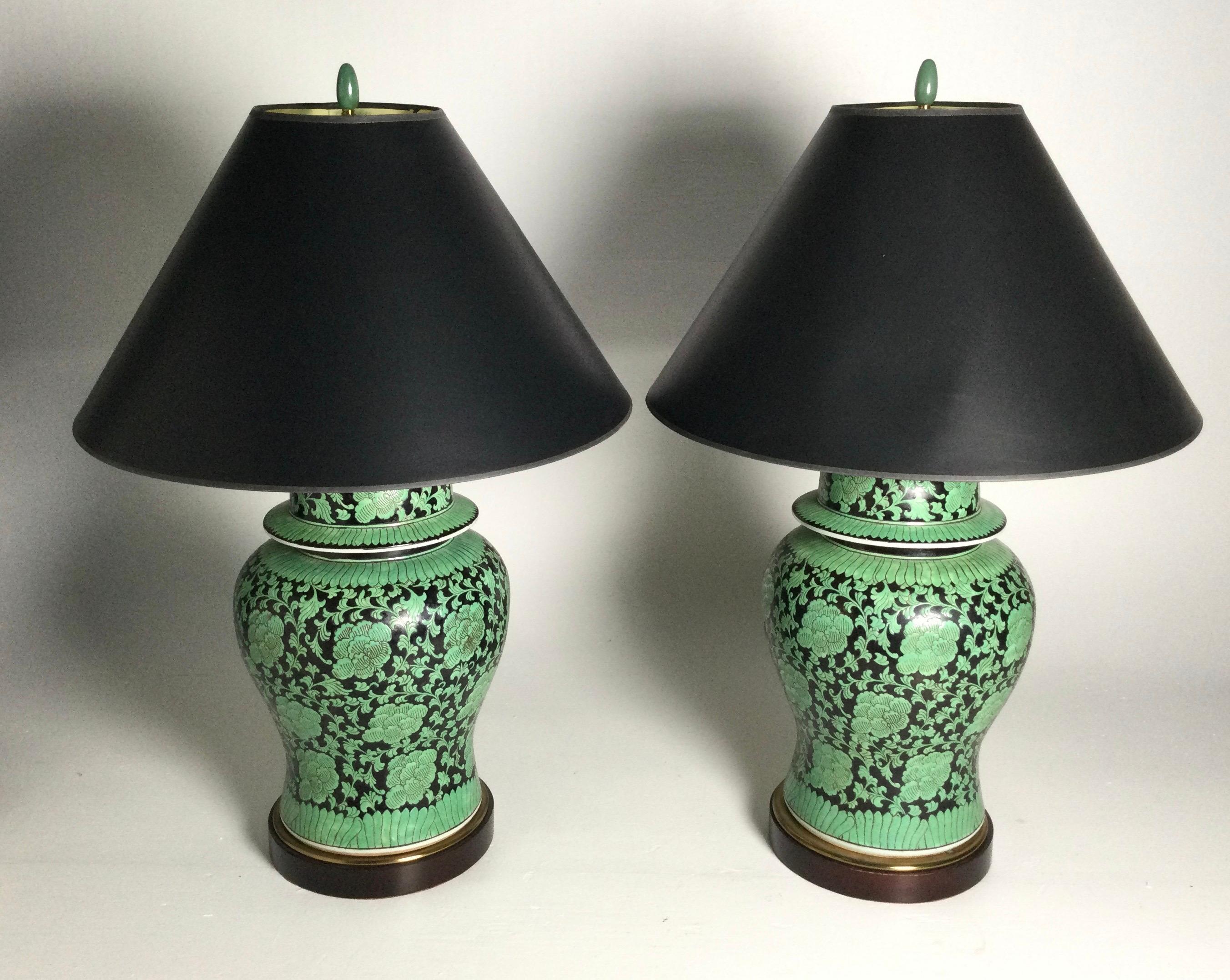 A large pair of black and green ginger jar urns now as lamps. The chines porcelain from the mid 20th century and make a striking pair of lamps. The shades for photographic purposes only and not included The height to the top of the shade is 32, to