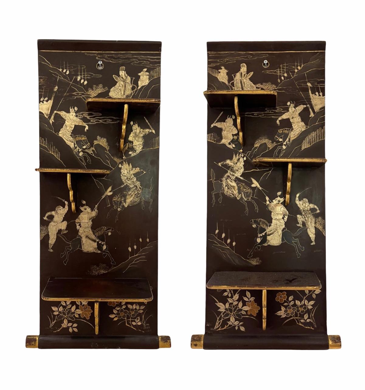 This beautiful Chinese export black lacquered pair of shelves is decorated with silver and gold leave images of the story of a Chinese warrior battle. Mini sterling sculptures and Netsukes are not included.
