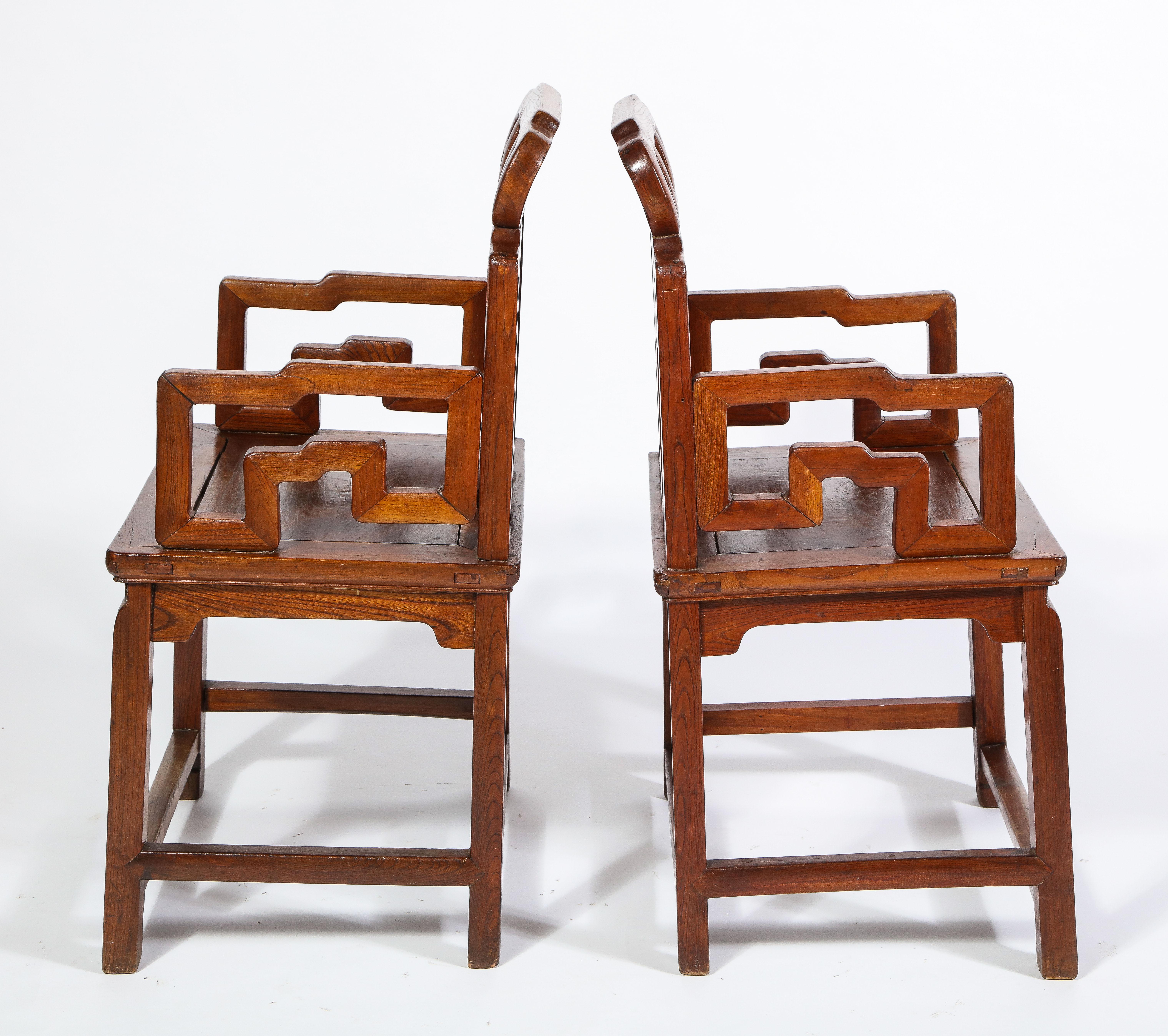Chinese Export Pair of Chinese Hardwood Chairs with Fretwork Designs and High Relief Panels For Sale