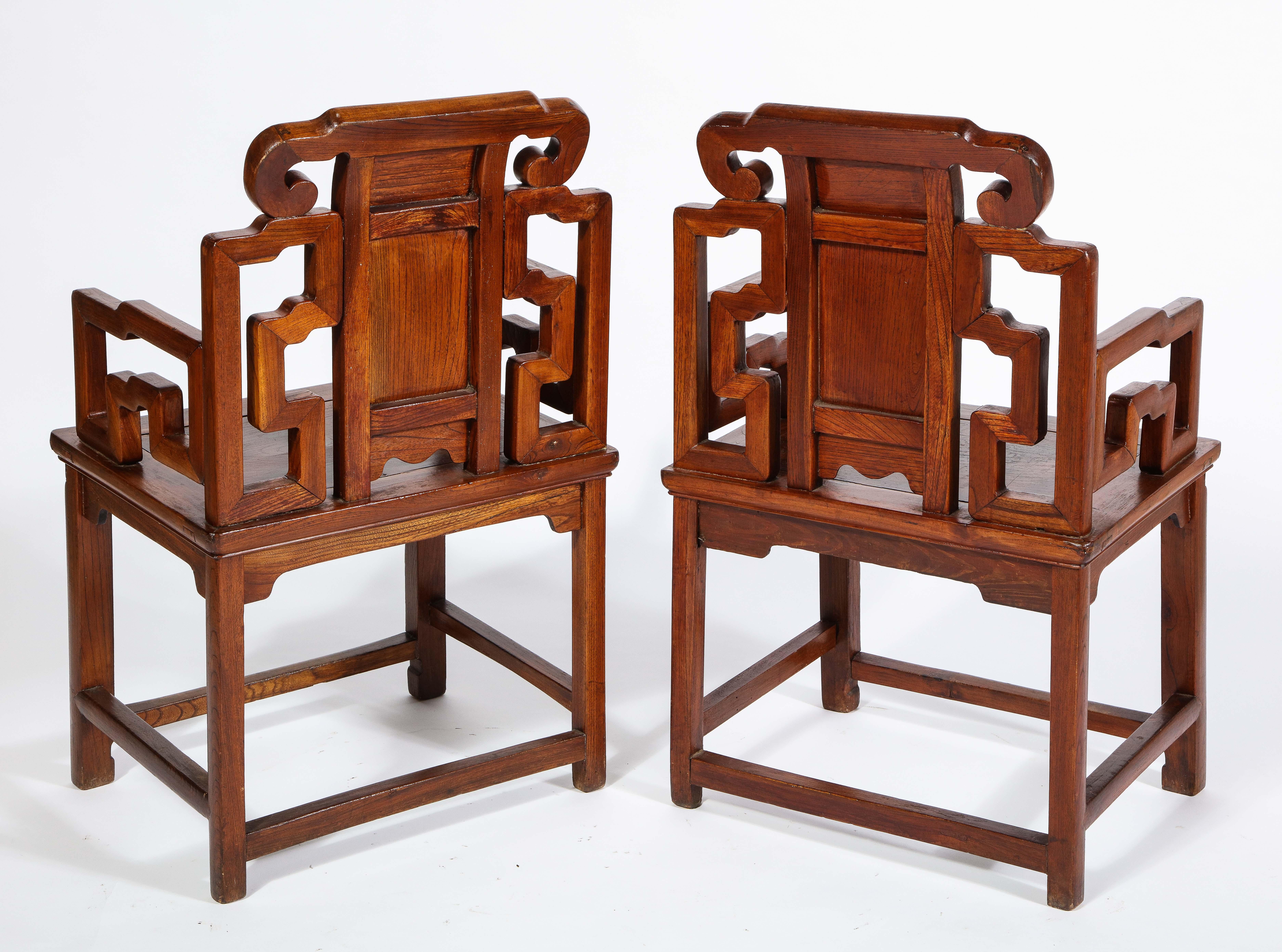Hand-Carved Pair of Chinese Hardwood Chairs with Fretwork Designs and High Relief Panels For Sale