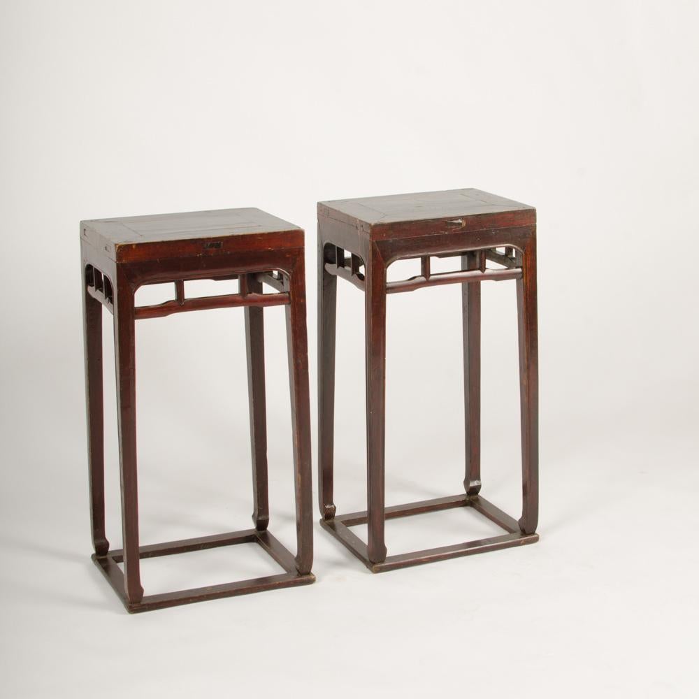 A pair of Chinese hardwood tall side tables/pedestals circa 1900 with box form stretchers.
