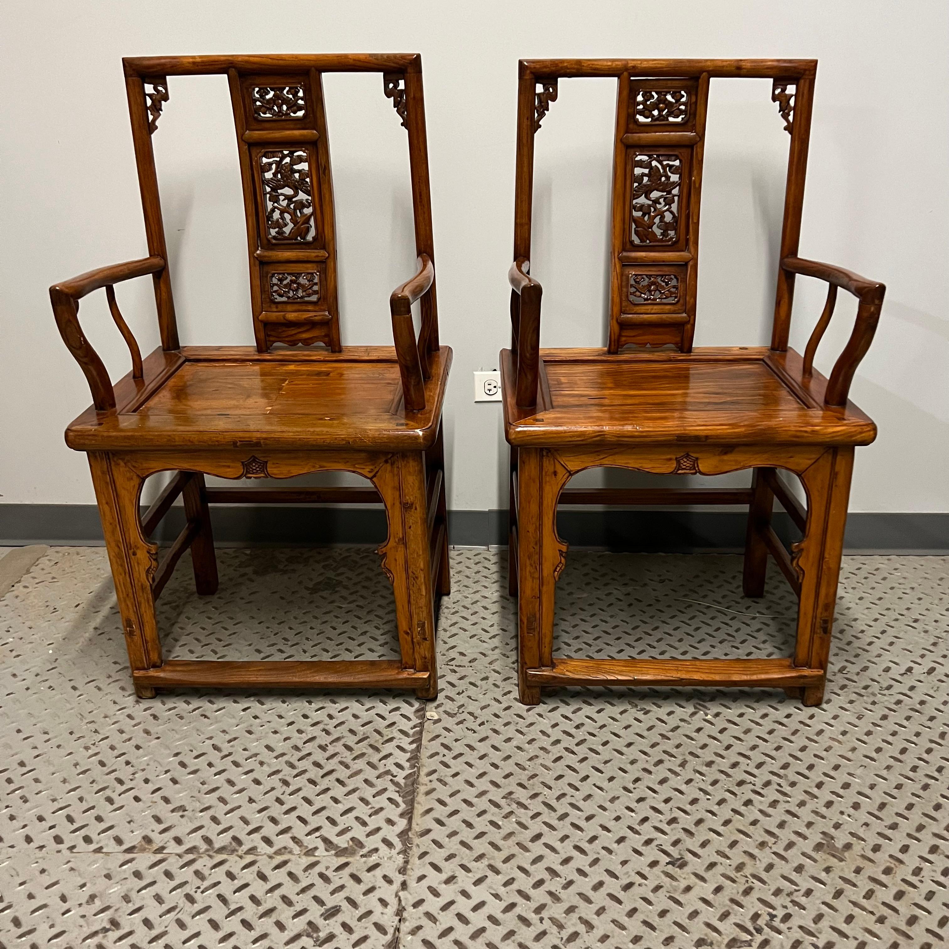 Lovely pair of Chinese officials chairs. Featuring a decorative back splat. Constructed with a mortise and tenon joinery and supported by square legs with a foot rest in the front. Also known as pagoda chairs, scholars chairs, and Guanmaoyi