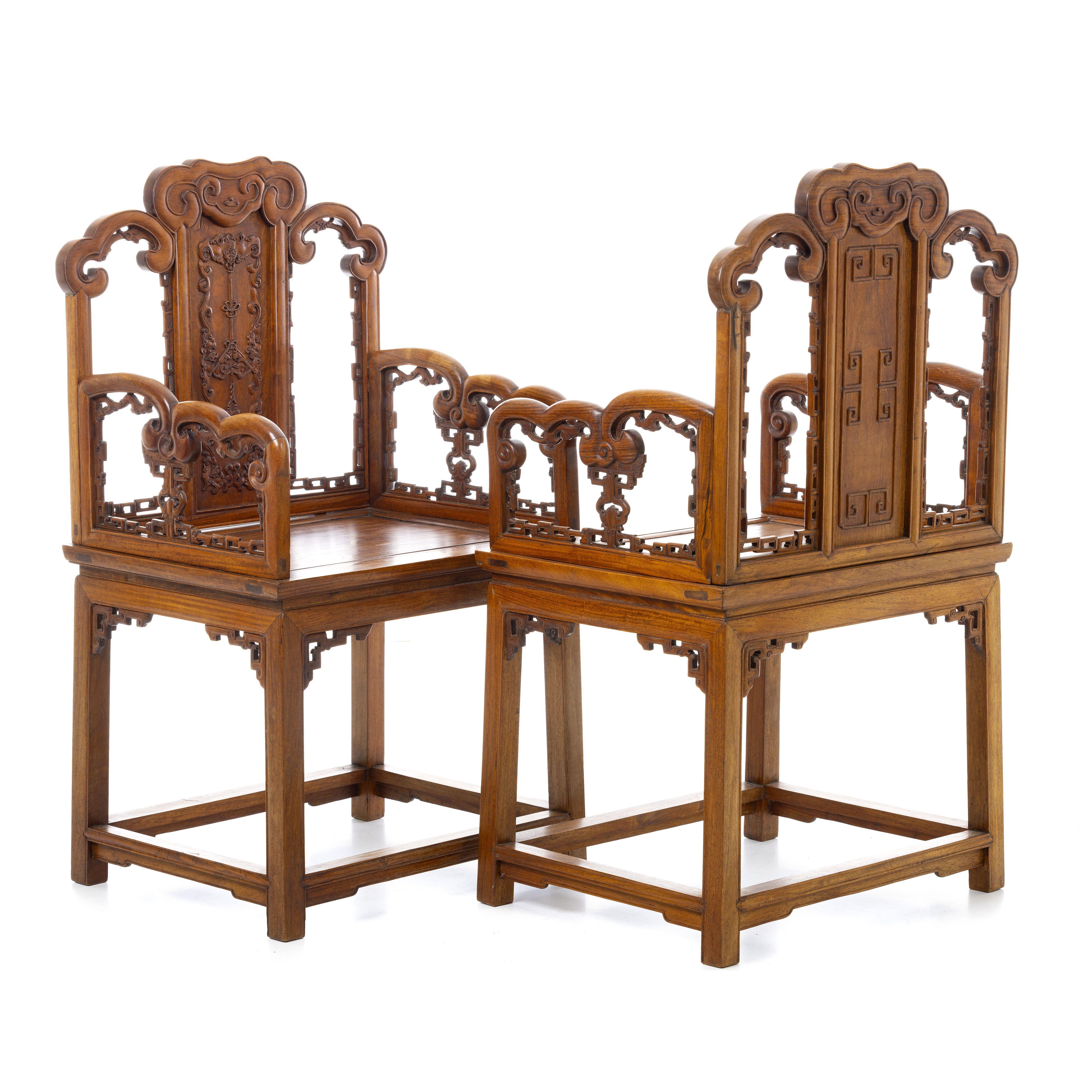 A fine and rare pair of Chinese huanguali wood armchairs dating from Guangxu period, very well carved decoration with fretwork friezes, ruyi and bat motifs on seat frame and armrests and auspicious emblems. A very fine quality pair and a wonderful