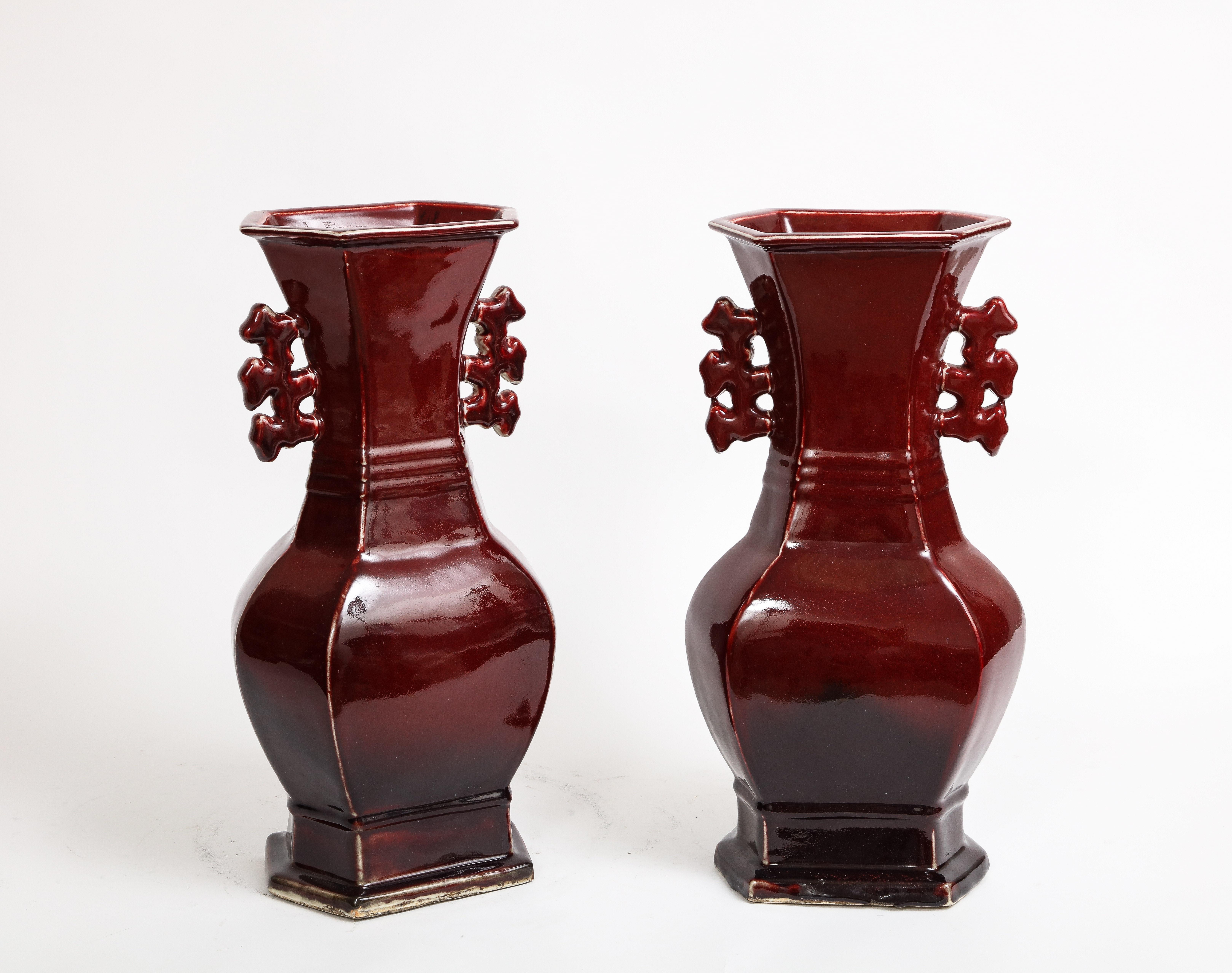 Chinese Export Pair of Chinese Monochrome Ox Blood Porcelain Double Handled Vases For Sale