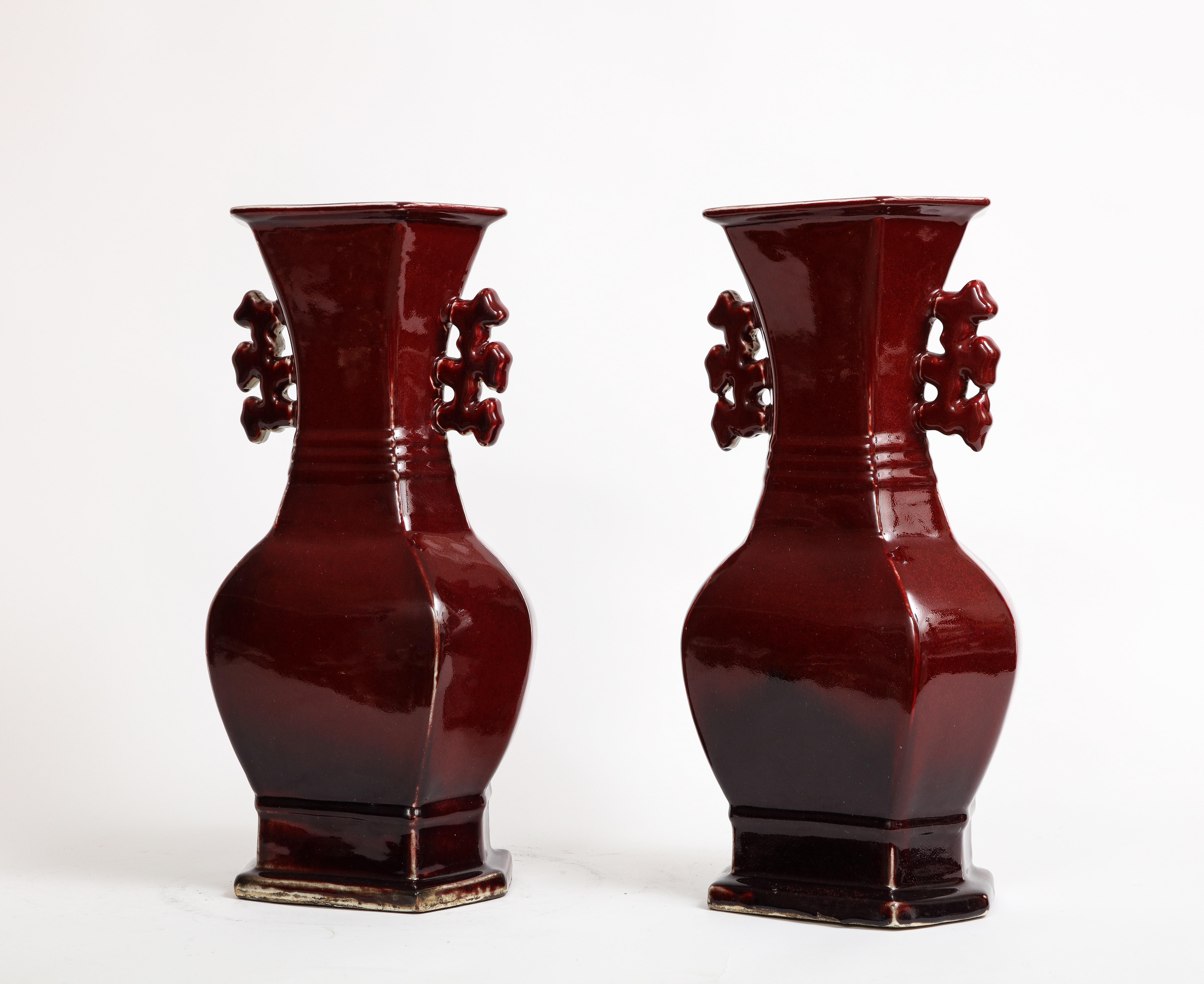 Mid-20th Century Pair of Chinese Monochrome Ox Blood Porcelain Double Handled Vases For Sale