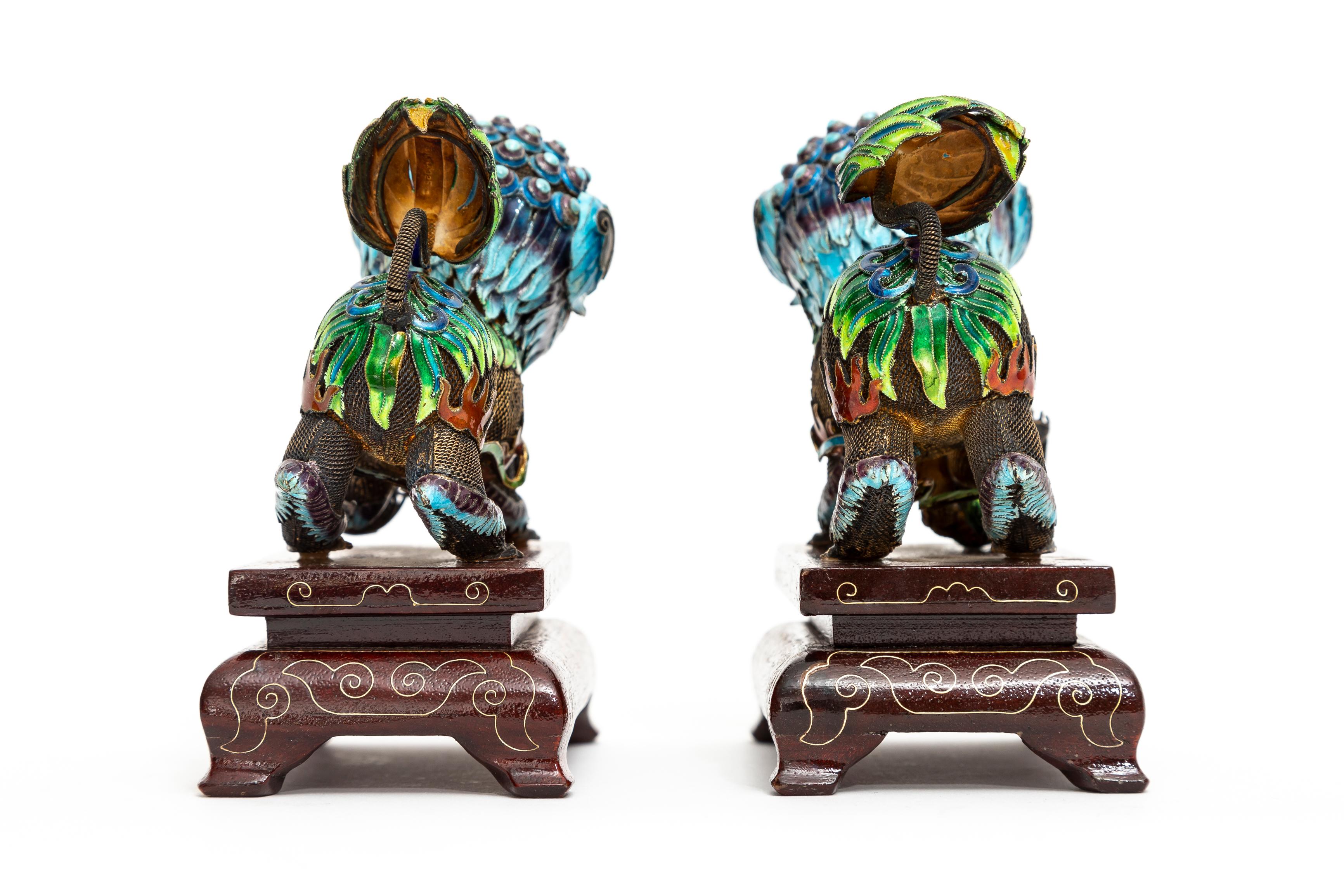 A Pair of Chinese Silver Filigree Enameled Foo Dogs on Carved Wood Stands In Good Condition For Sale In New York, NY