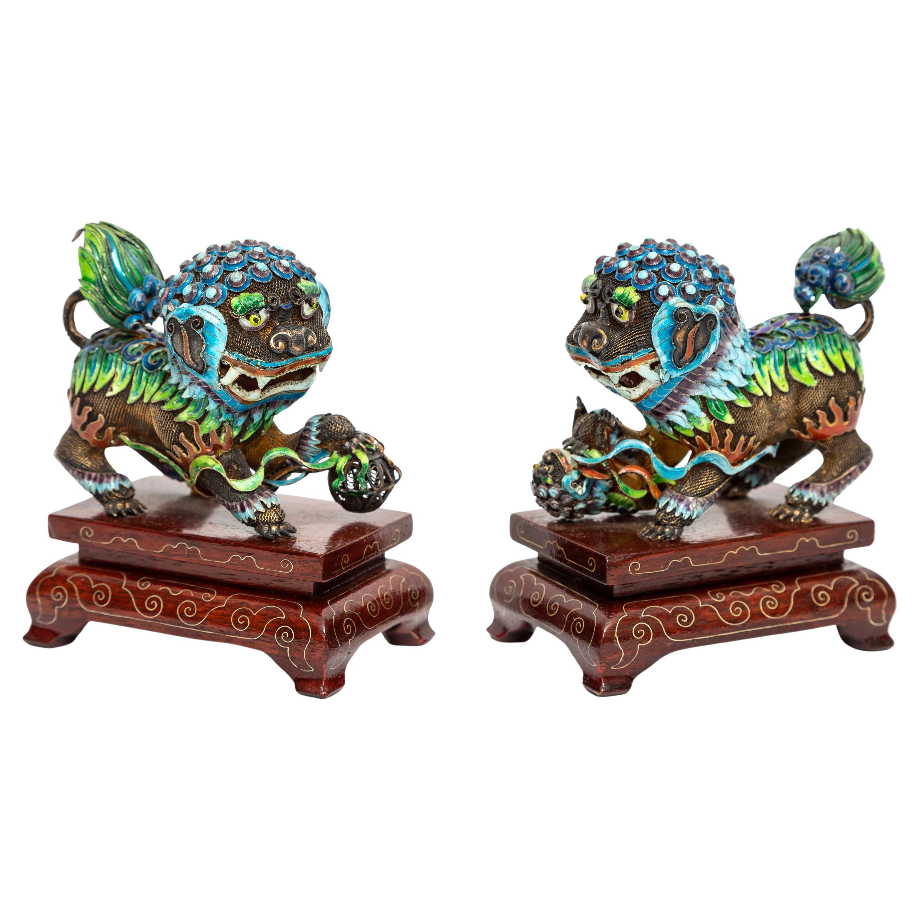 A Pair of Chinese Silver Filigree Enameled Foo Dogs on Carved Wood Stands For Sale