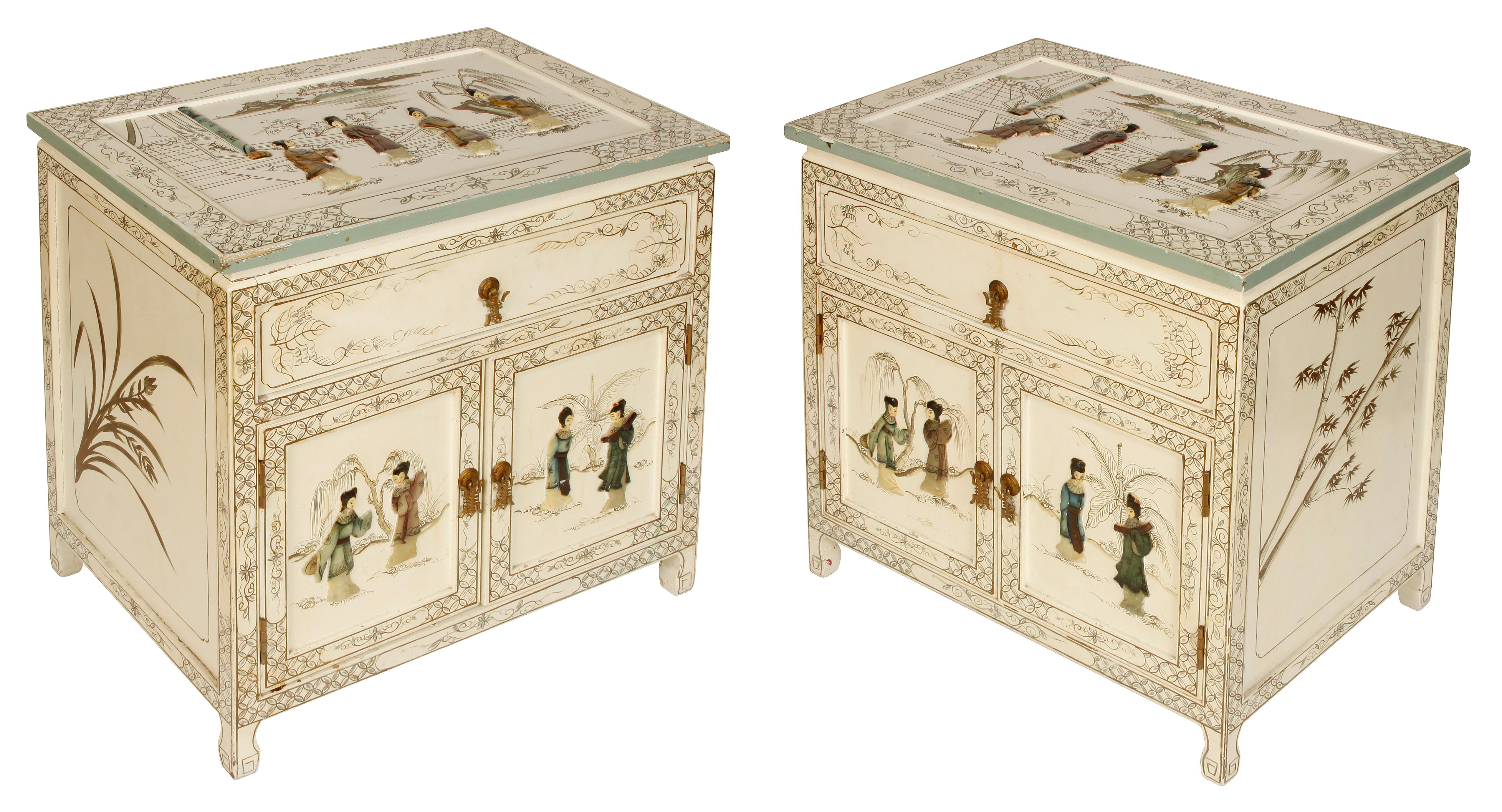 A pair of white chinoiserie painted bedside tables. Embellished with colored stone figures to tops and front doors. Painted with gold branches and detailed border.