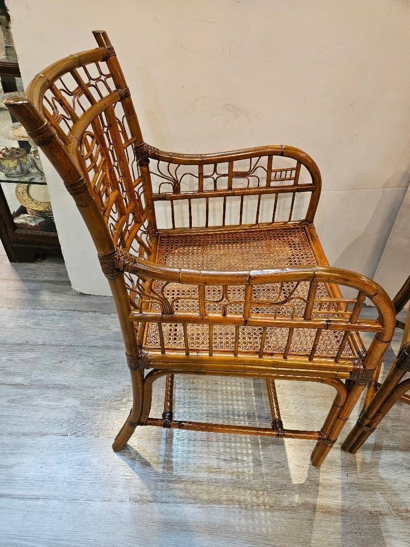 A chic pair of beautifully made bamboo armchairs, The Chinoiserie style bamboo frames with cane seats with a neutral stripe seat cushion.  Mid 20th Century made by Century Furniture