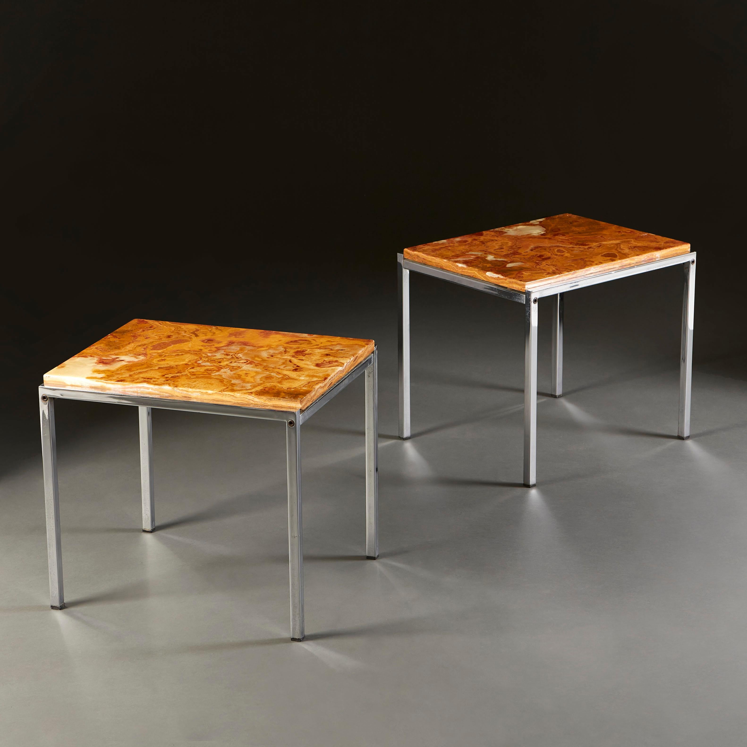 A pair of 1970s modernist occasional tables with solid onyx tops, supported on a chrome base with four square legs.