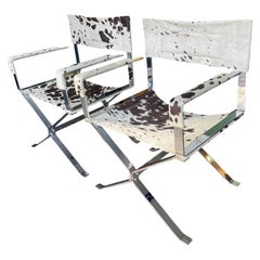 A pair of chrome directors chairs by Alessandro Albrizzi with rare cowhide seats