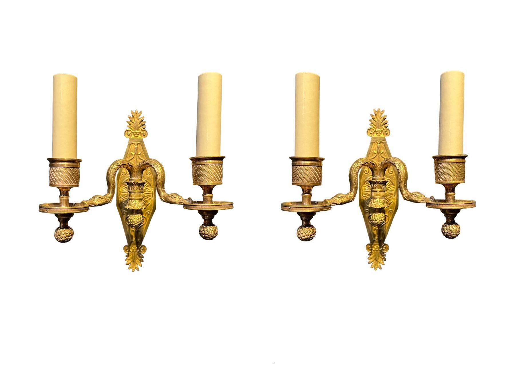 A pair of circa 1900 French Empire sconces with swan's head