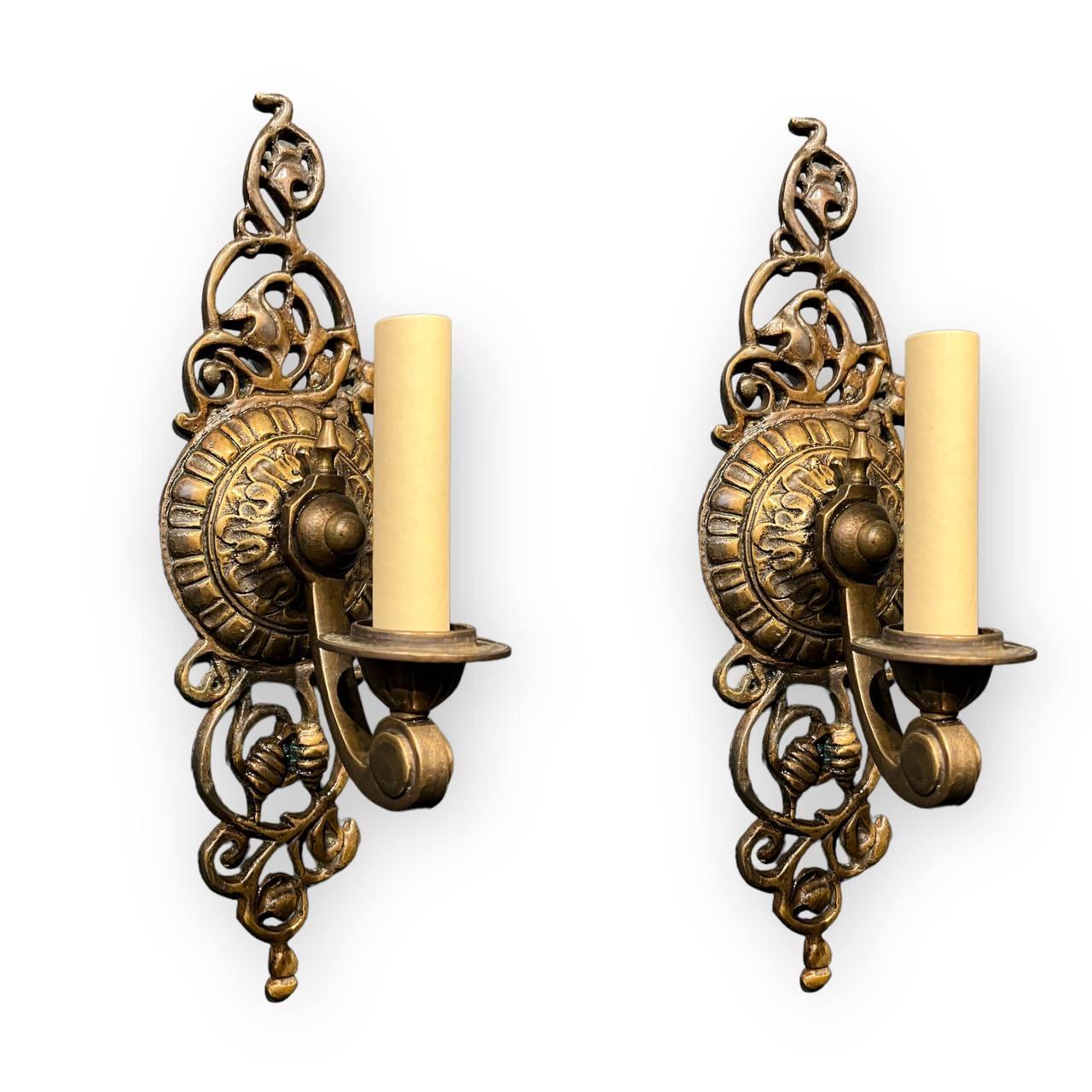 A pair of circa 1920's brown patinated bronze sconces with one light