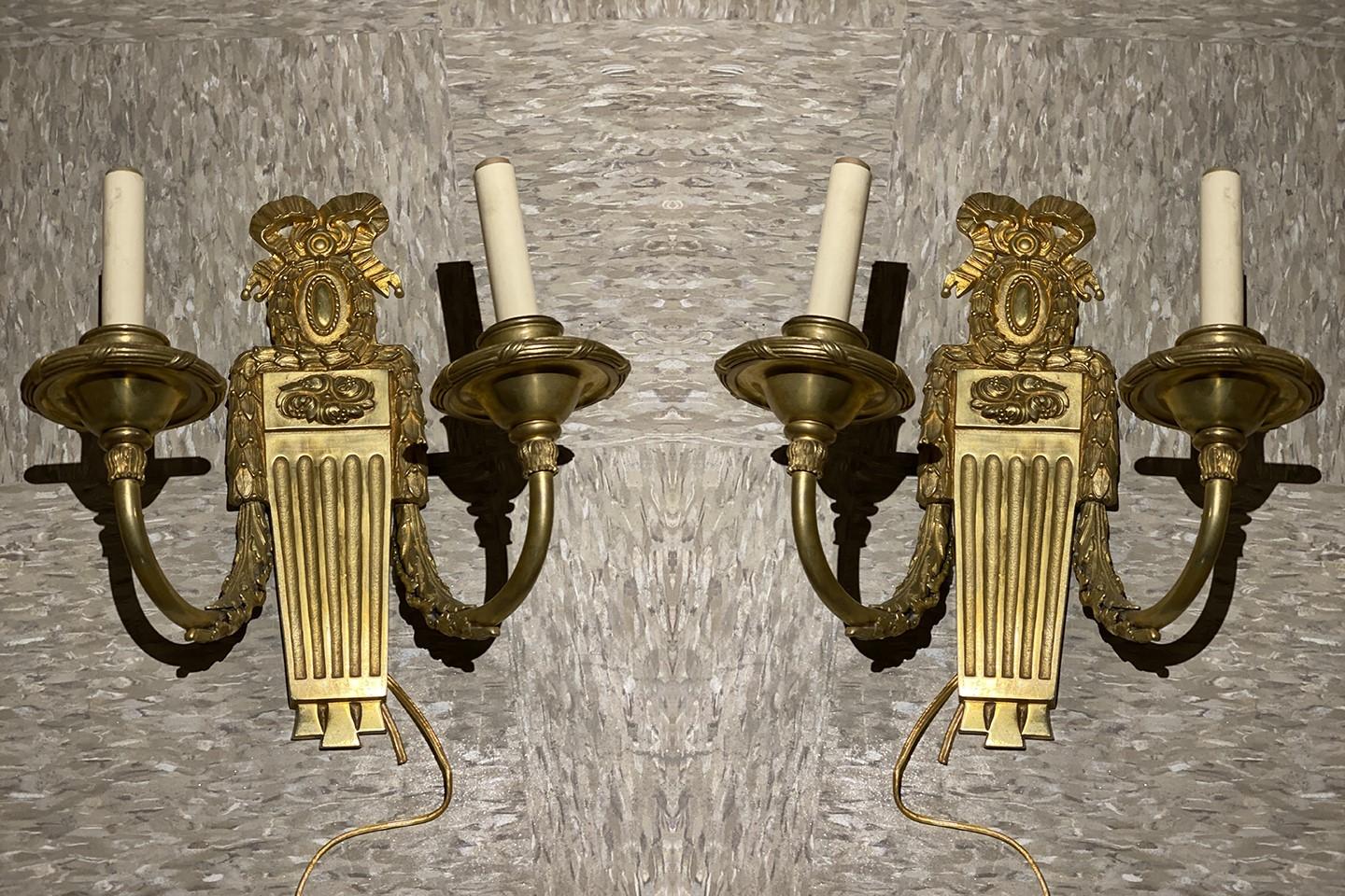 A pair of circa 1920's Caldwell gilt bronze neoclassical sconces with two lights