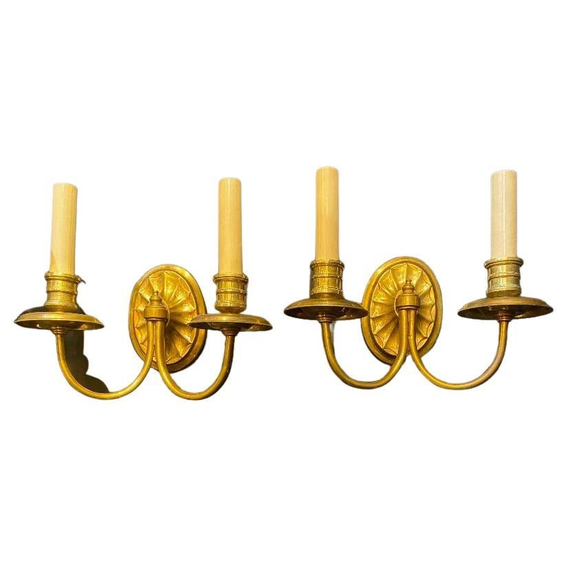 A pair of circa 1920's Caldwell small gilt bronze double light sconces, original gilding.