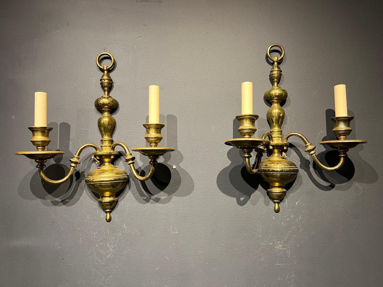 A pair of circa 1920's Caldwell brown patinated bronze sconces with two lights