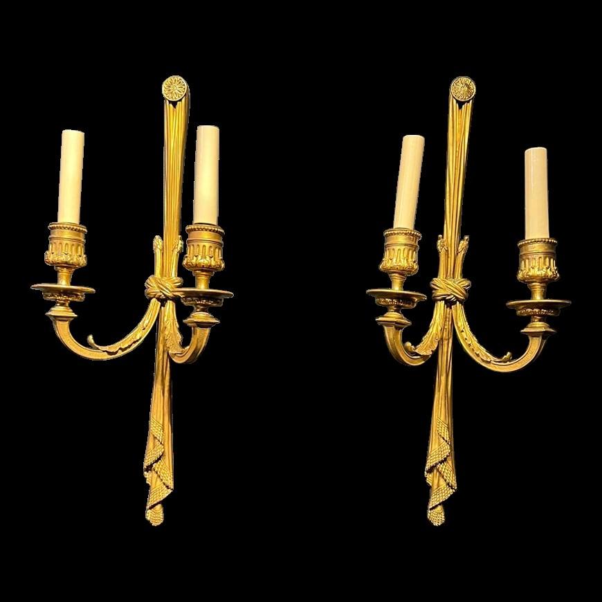 A pair of circa 1920's Caldwell gilt bronze double lights sconces in Louis XVI style 