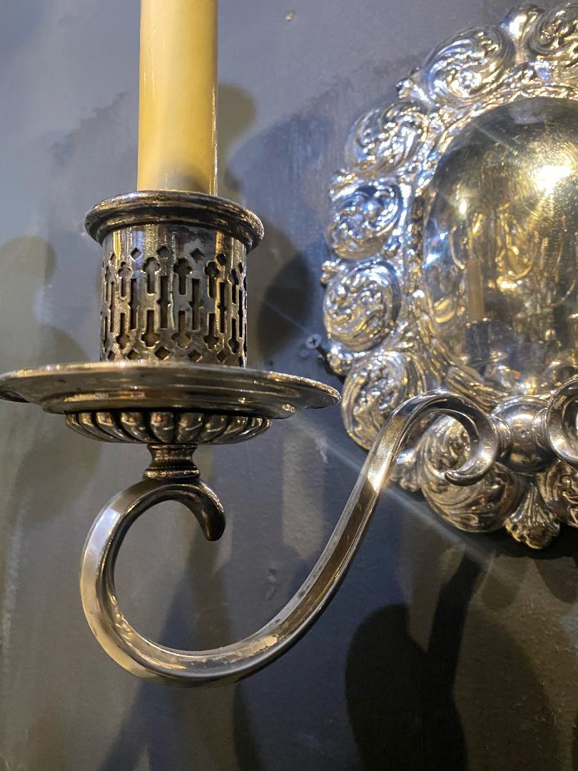 A pair of circa 1920's Caldwell silver plated sconces with waves design and unusual arms, two lights