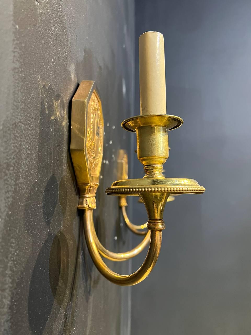 A pair of circa 1910's Caldwell double light sconces with neoclassic design.Original finish.