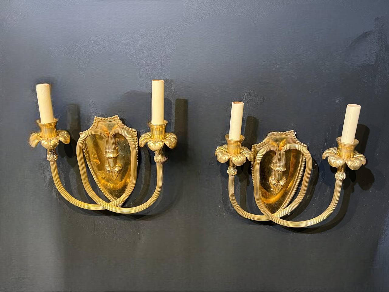 A pair of circa 1920’s Caldwell double light sconces with scrolled arms
