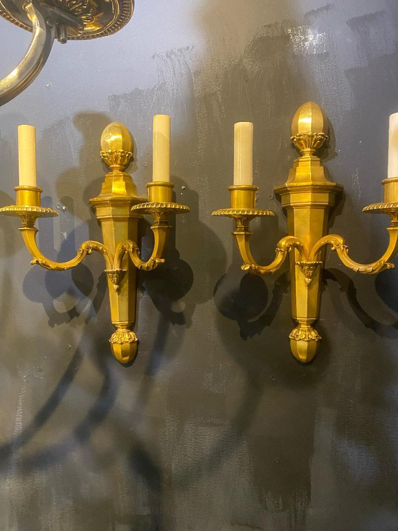 A pair of circa 1920's Caldwell double light gilt bronze sconces