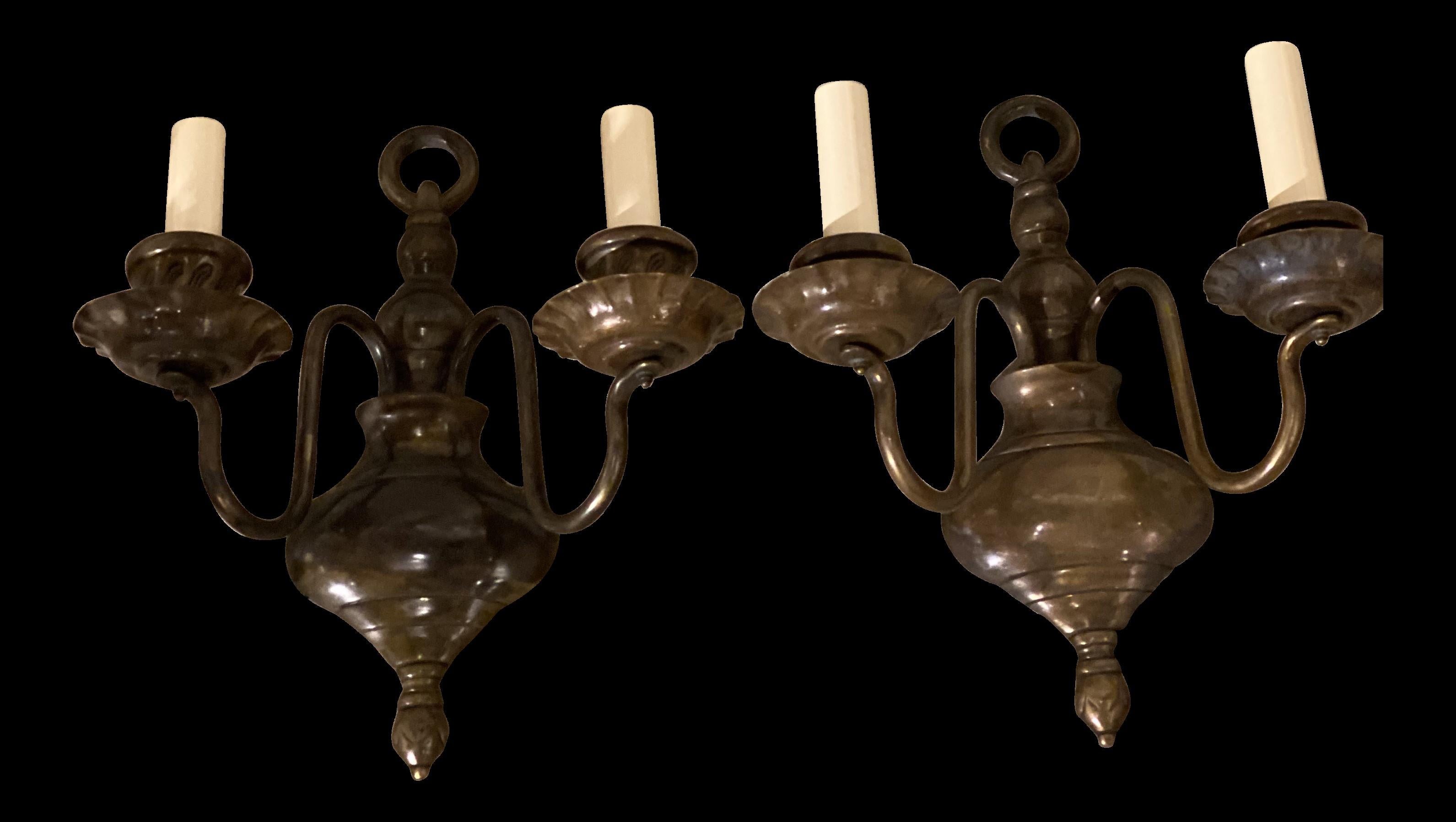 A pair of circa 1920's Caldwell brown patinated bronze double light sconces